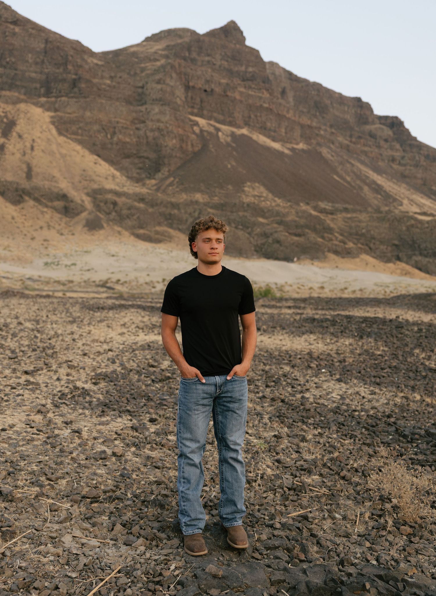 High school senior portrait in a rugged mountain landscape during an adventurous outdoor senior session.