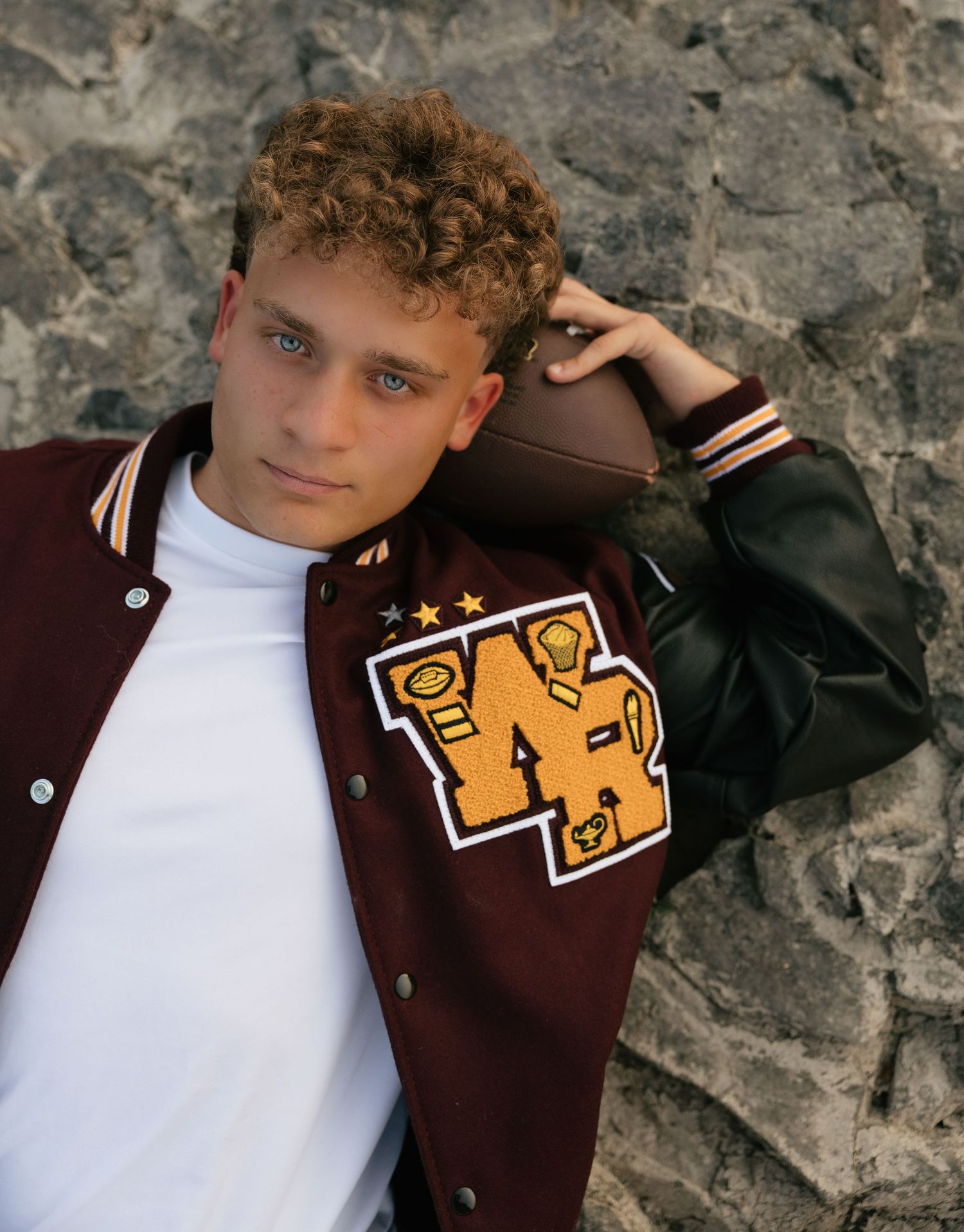High school senior posing in his letterman jacket during a Washington senior portrait session.