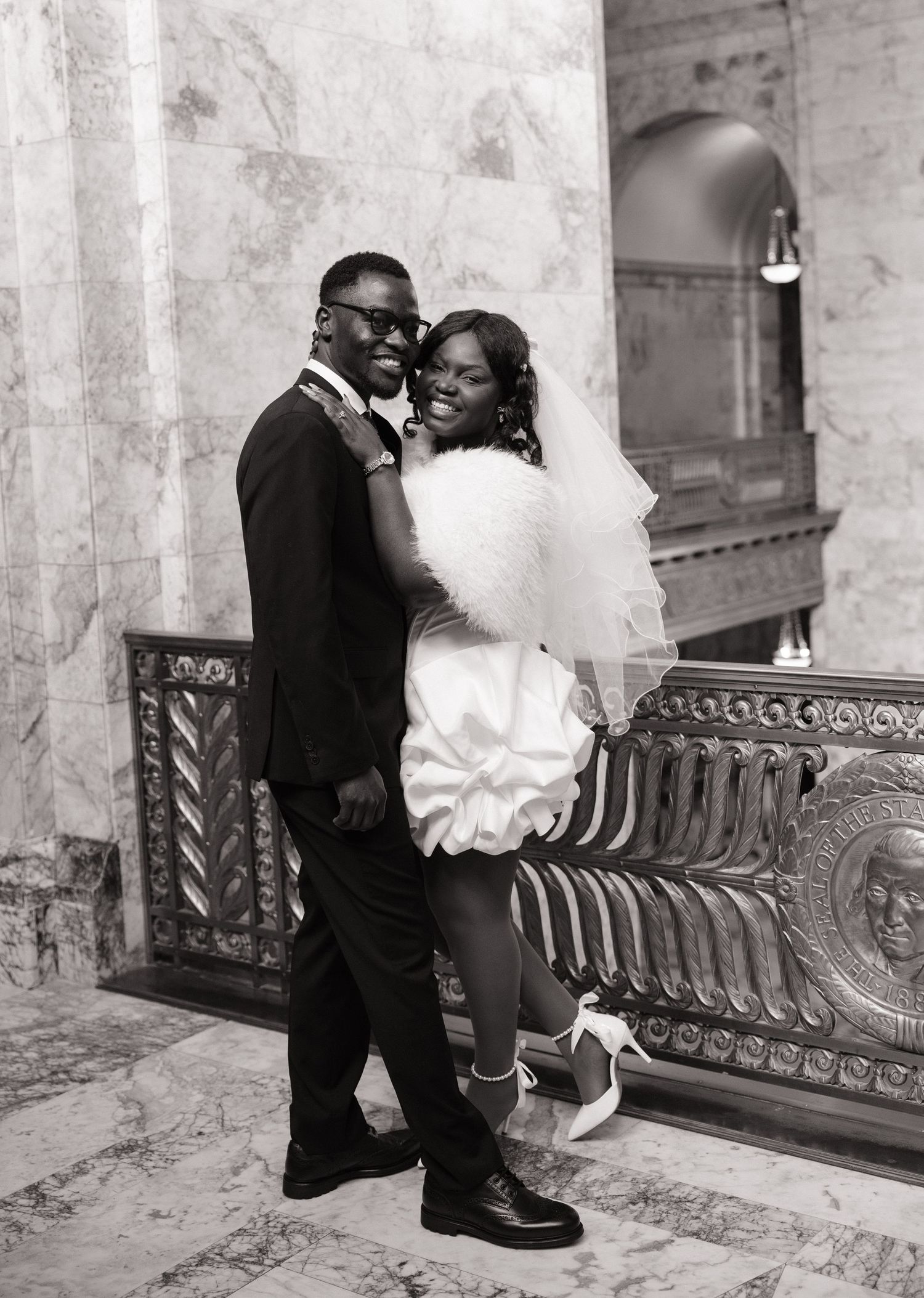 Newlyweds smiling together during their Washington State Capitol wedding portraits