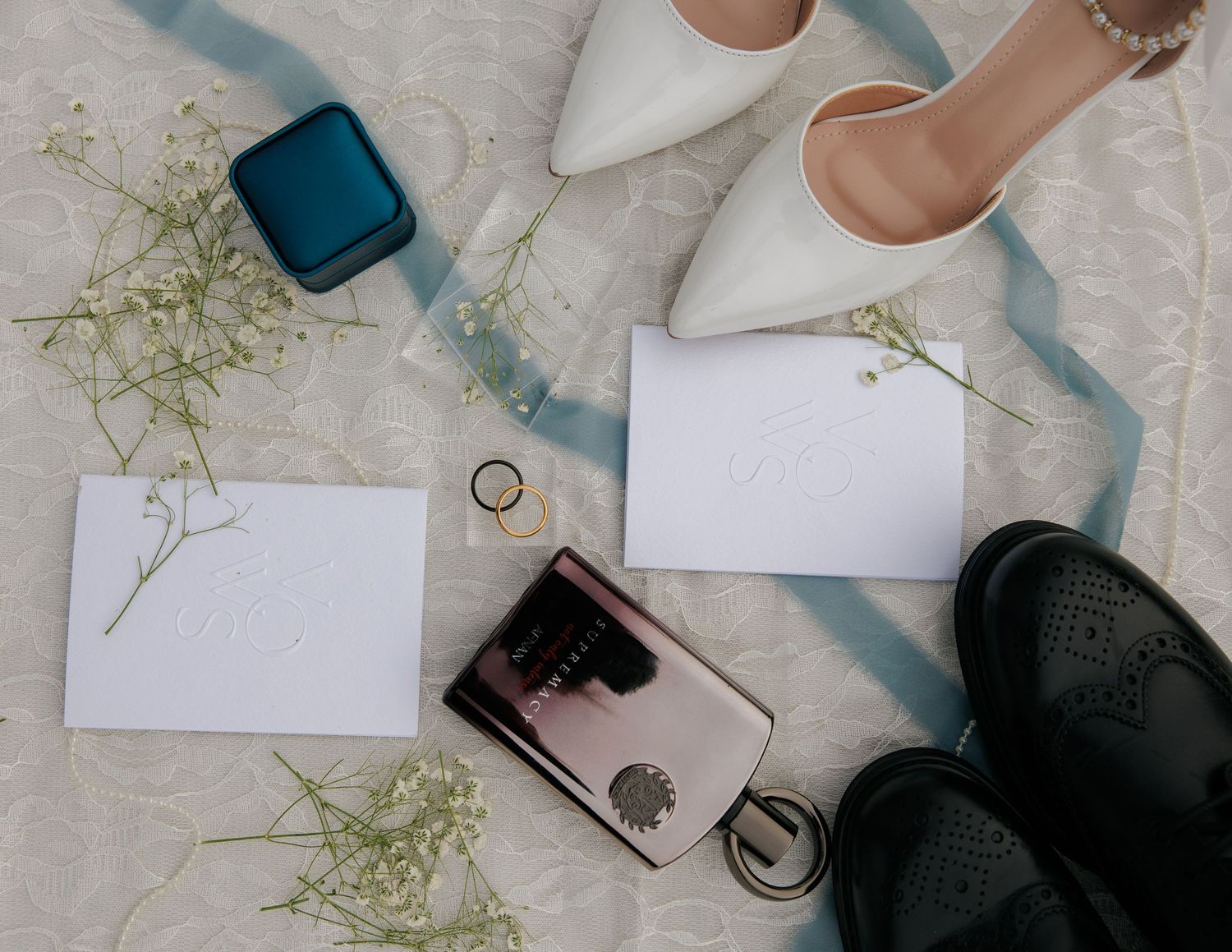 Wedding detail flat lay with the newlyweds’ shoes, rings and keepsakes from their Olympia wedding