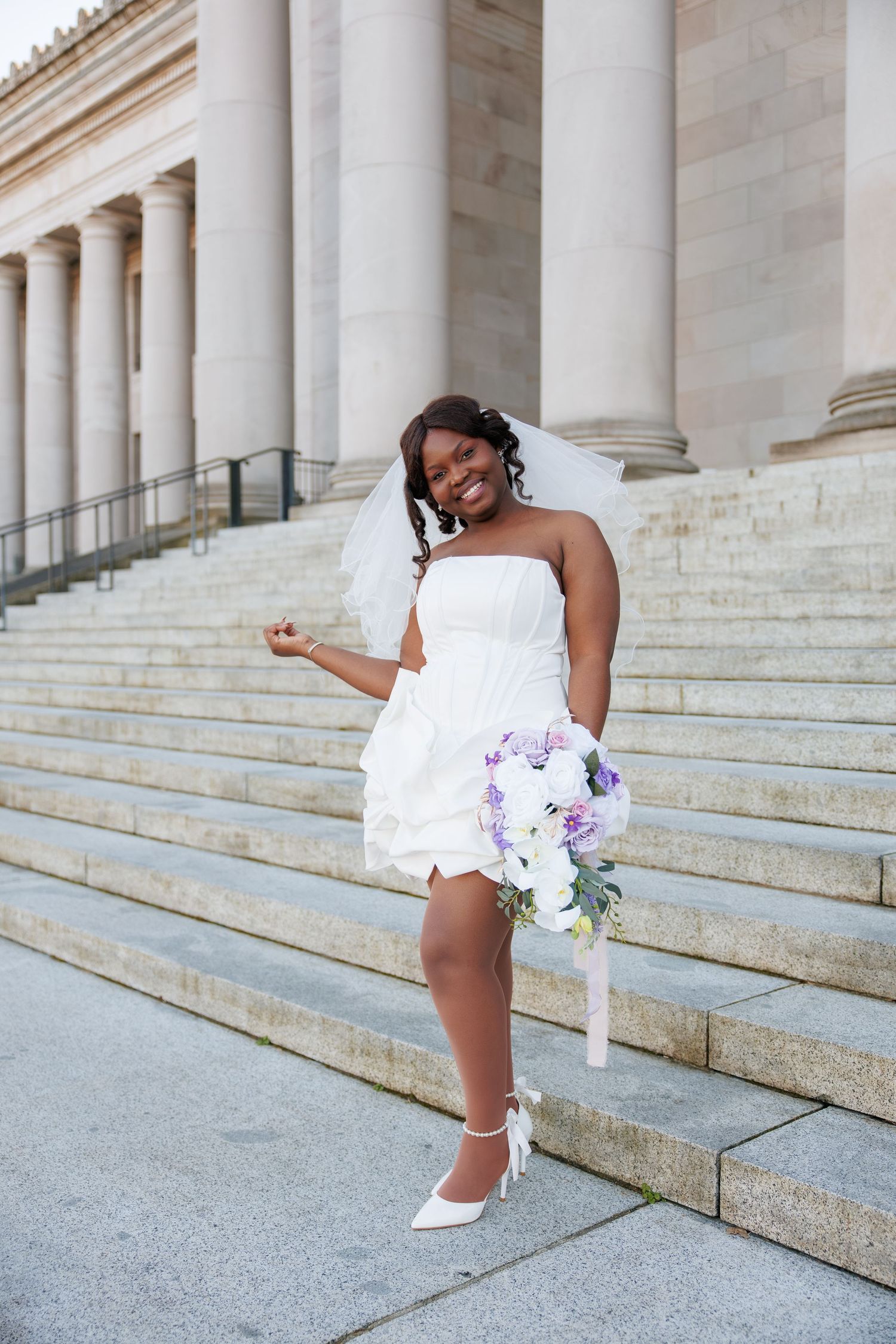 Bride smiling with her bouquet during her Washington State Capitol wedding portraits