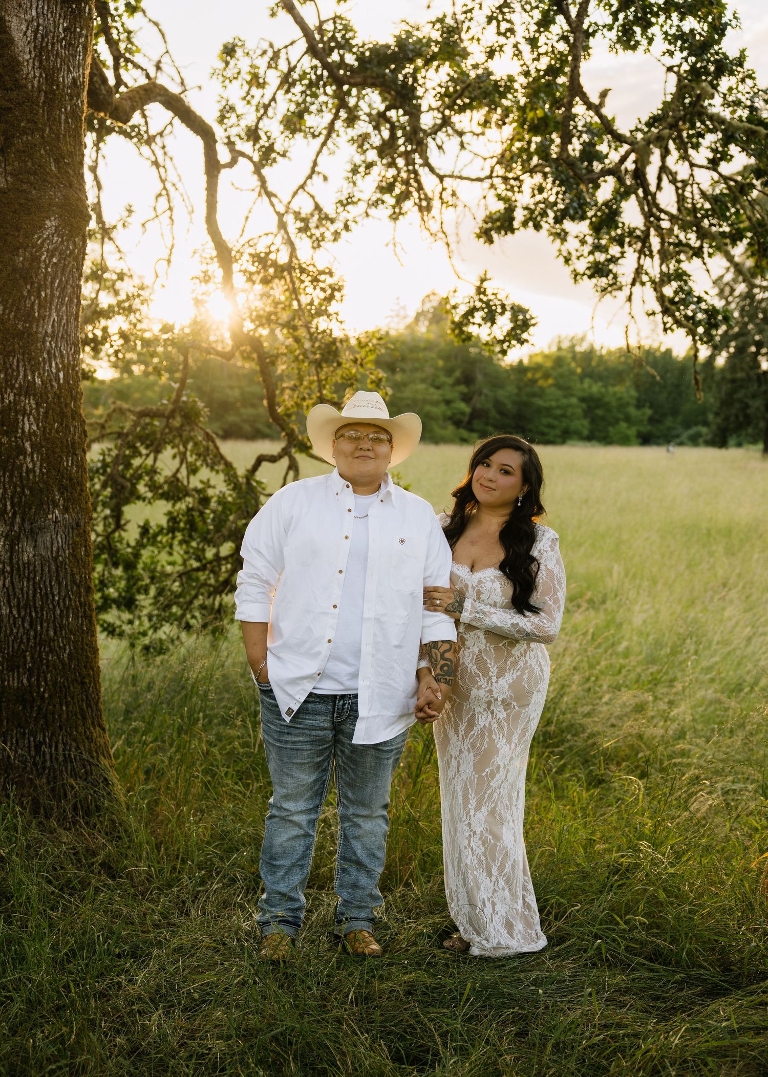 Couple engagement portrait in a sunlit field during a romantic outdoor photography session in Washington.