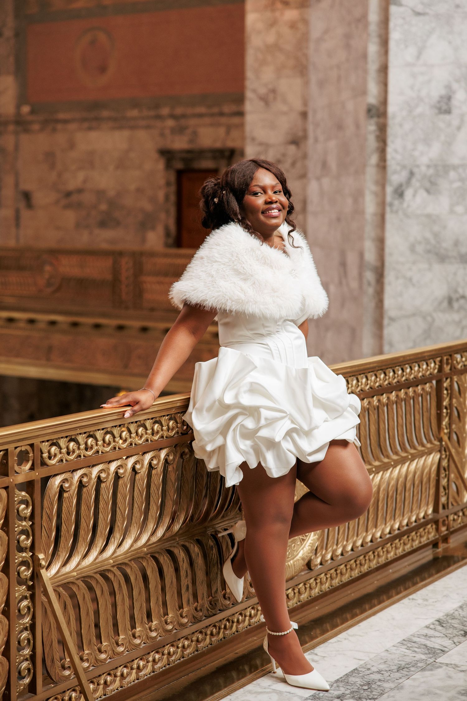 Bride smiling during her wedding portraits inside the Washington State Capitol