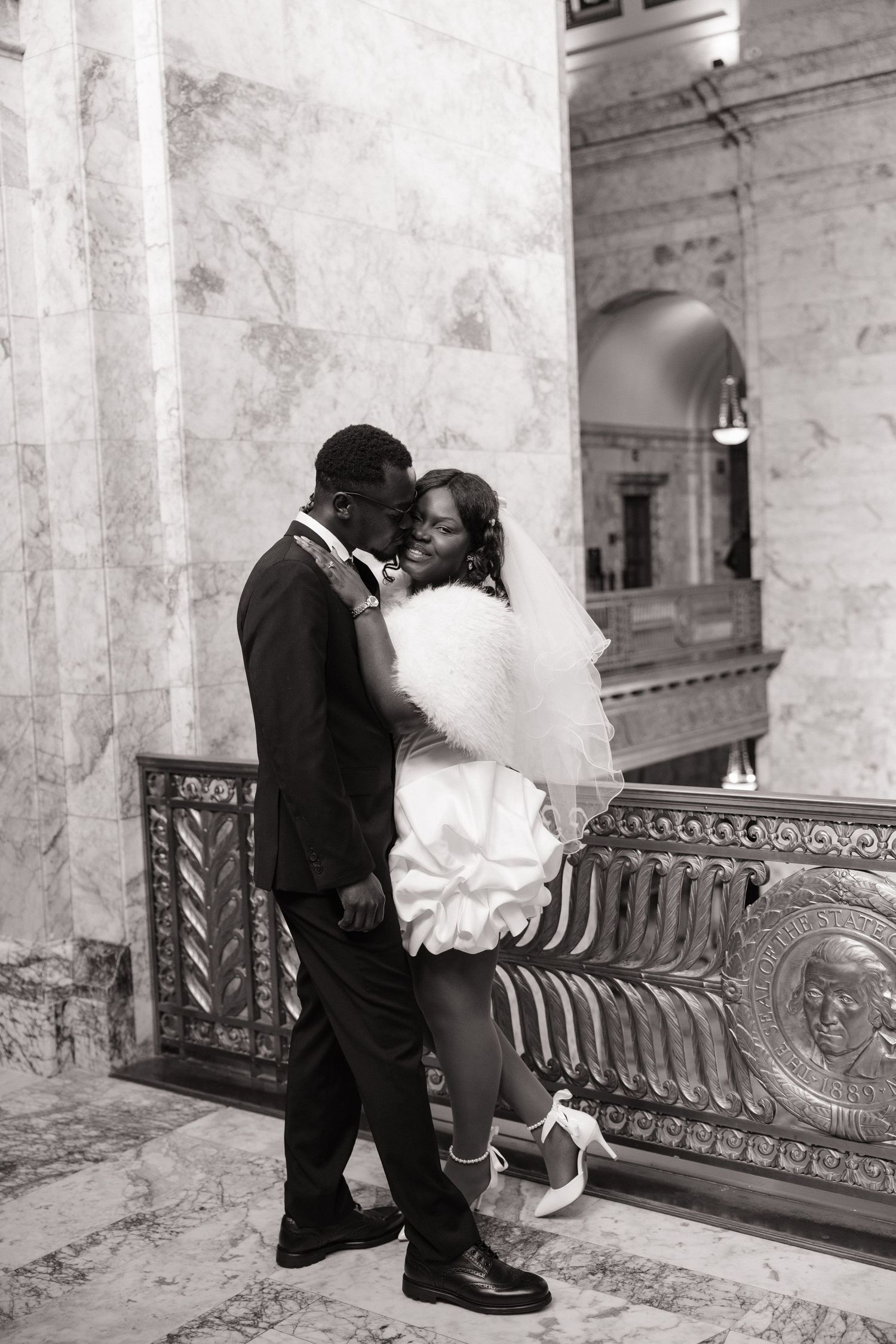 Bride and groom sharing a romantic moment inside the Washington State Capitol in Olympia
