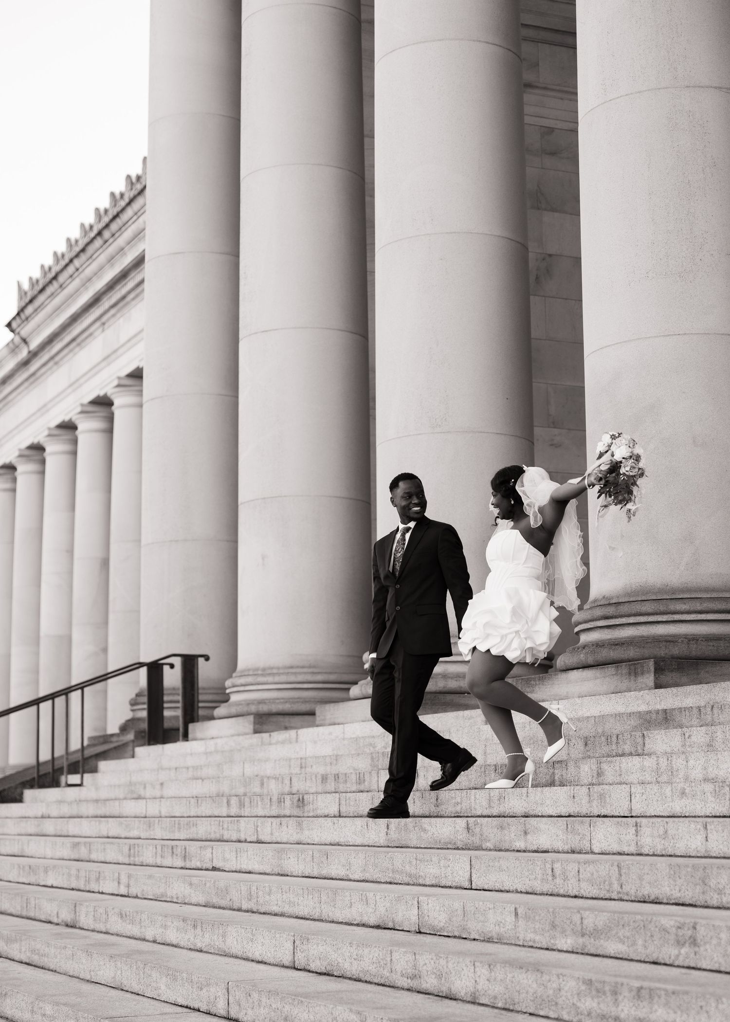 Newlyweds celebrating on the Washington State Capitol steps in Olympia