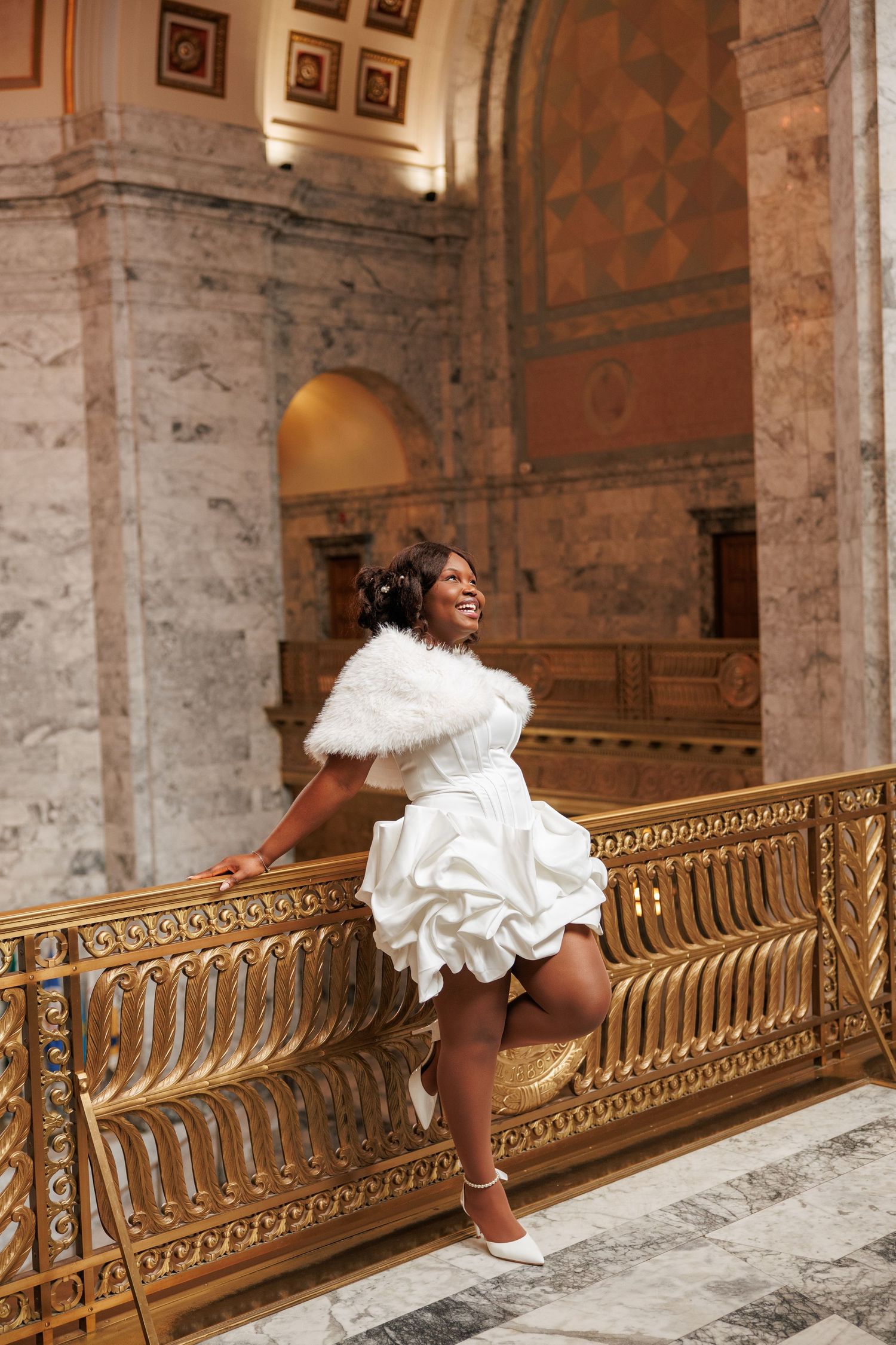 Bride laughing during her wedding portrait inside the Washington State Capitol in Olympia