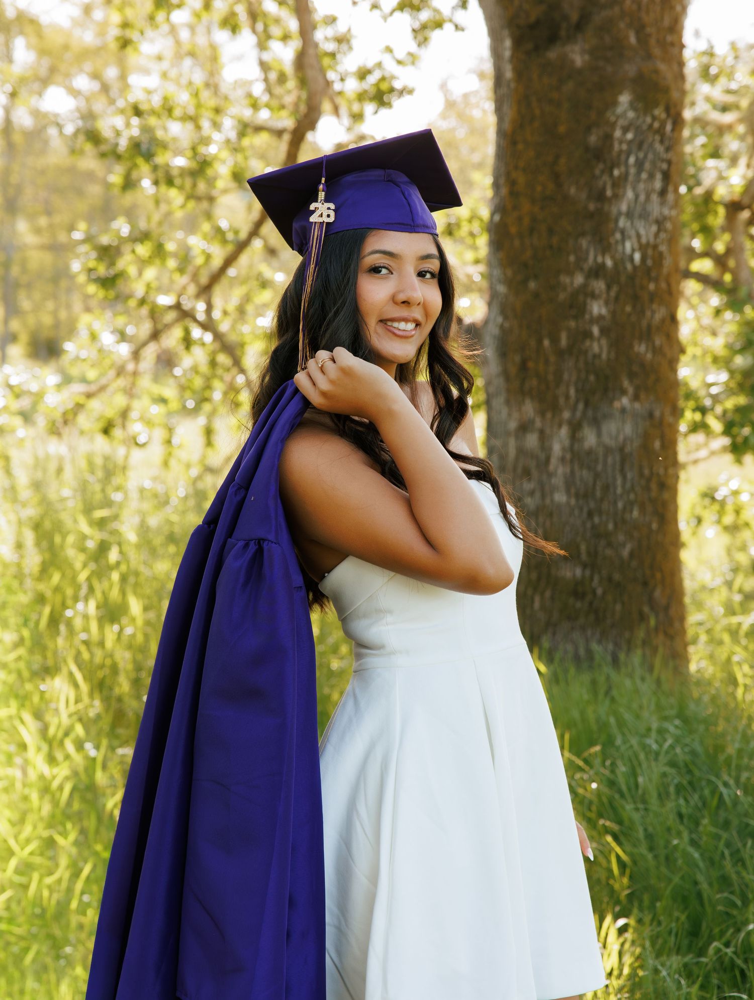 High school senior in her graduation cap and gown during an outdoor Washington senior photography session.