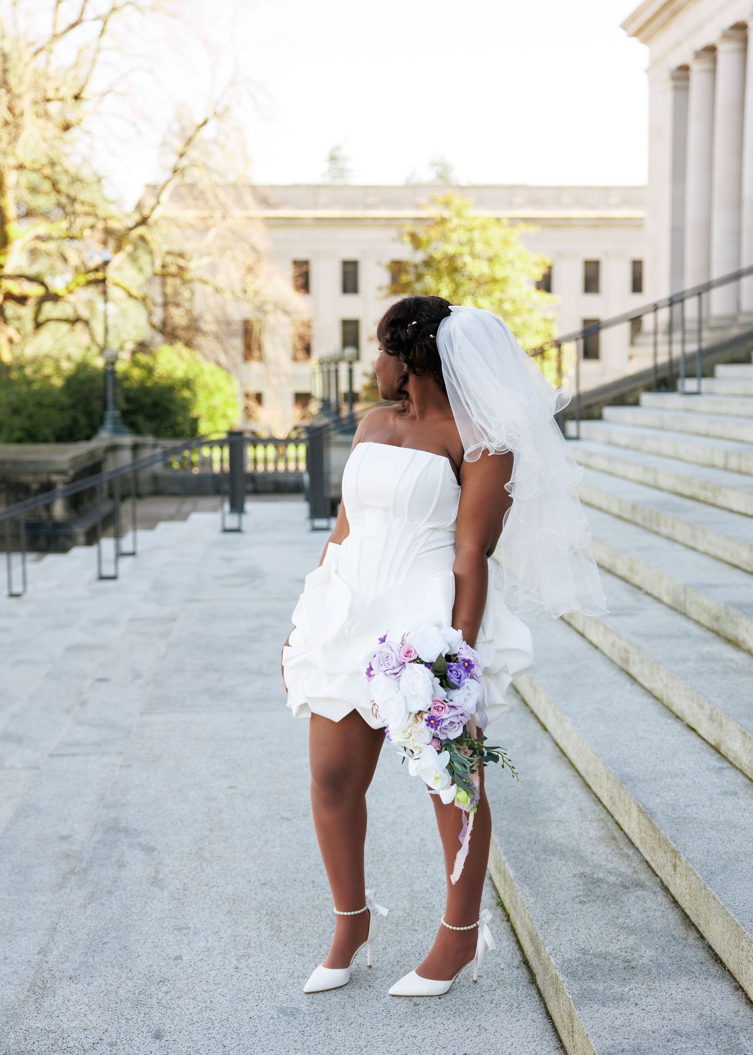 Bride posing with her bouquet outside the Washington State Capitol in Olympia