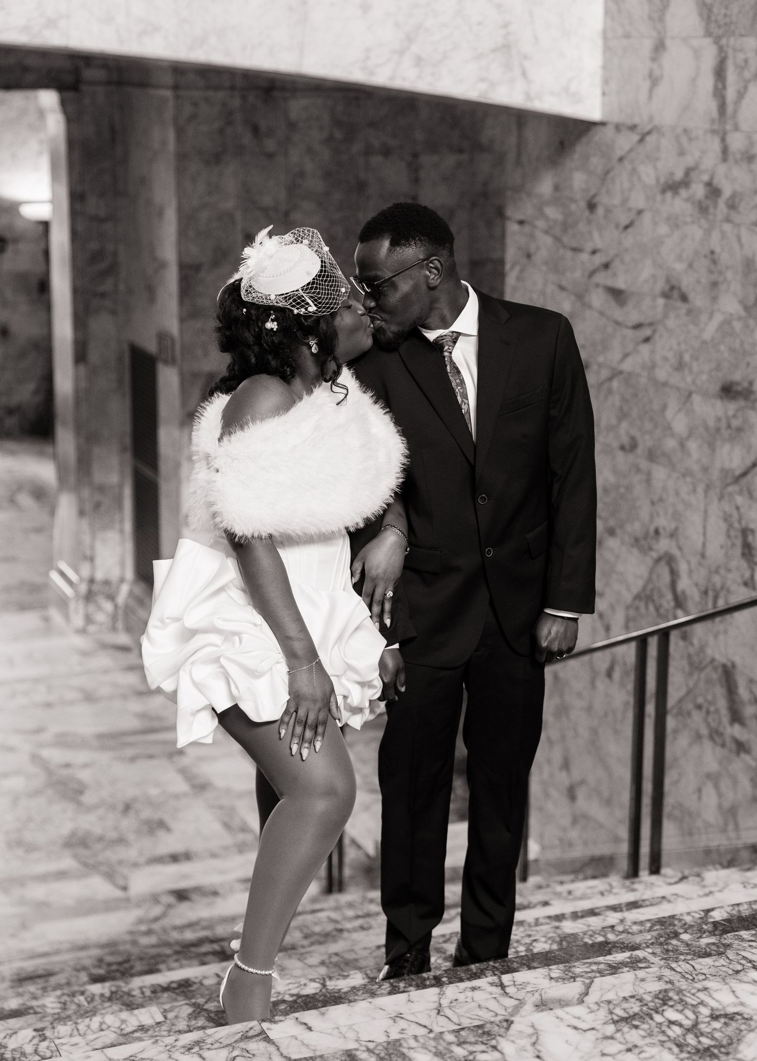 Bride and groom sharing a kiss on the marble stairs of the Washington State Capitol in Olympia