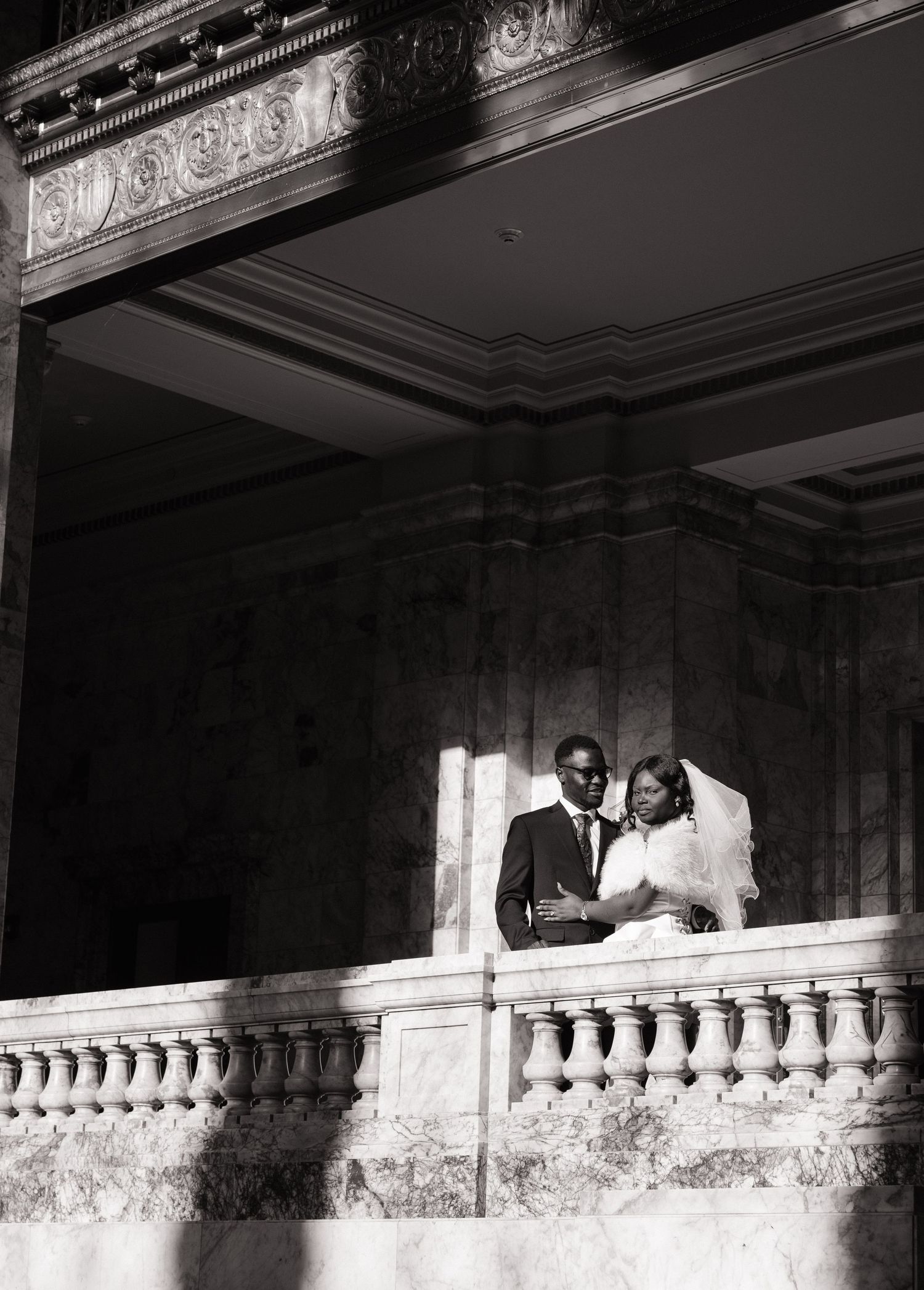 Bride and groom framed by the architecture of the Washington State Capitol in Olympia