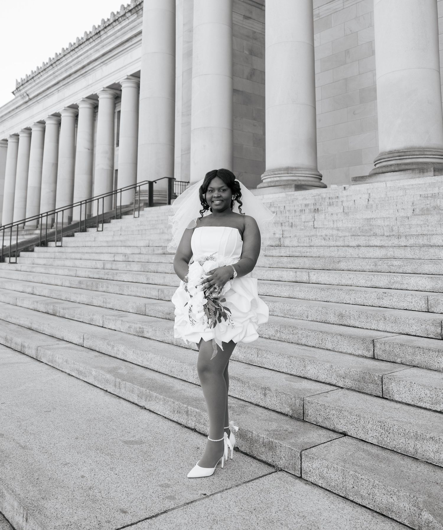 Bride posing on the Washington State Capitol steps in Olympia on her wedding day