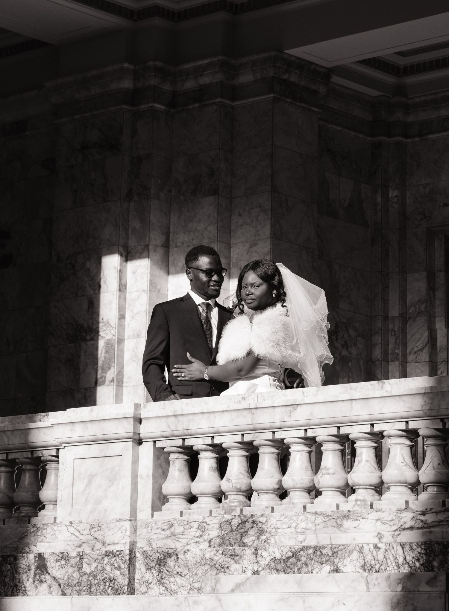 Black and white wedding portrait of newlyweds on a Washington State Capitol balcony