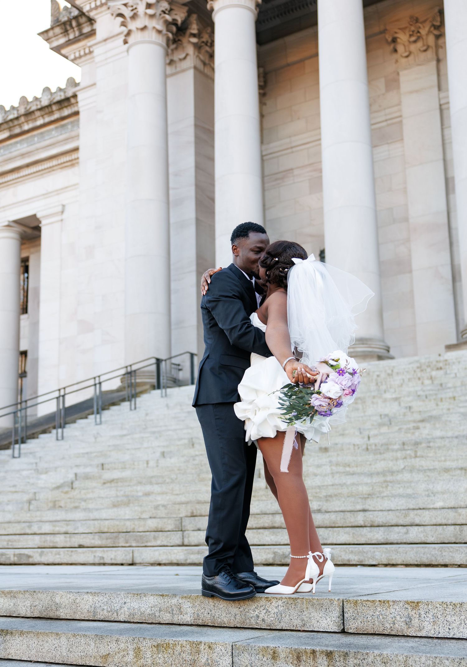 Bride and groom kissing on the Washington State Capitol steps in Olympia