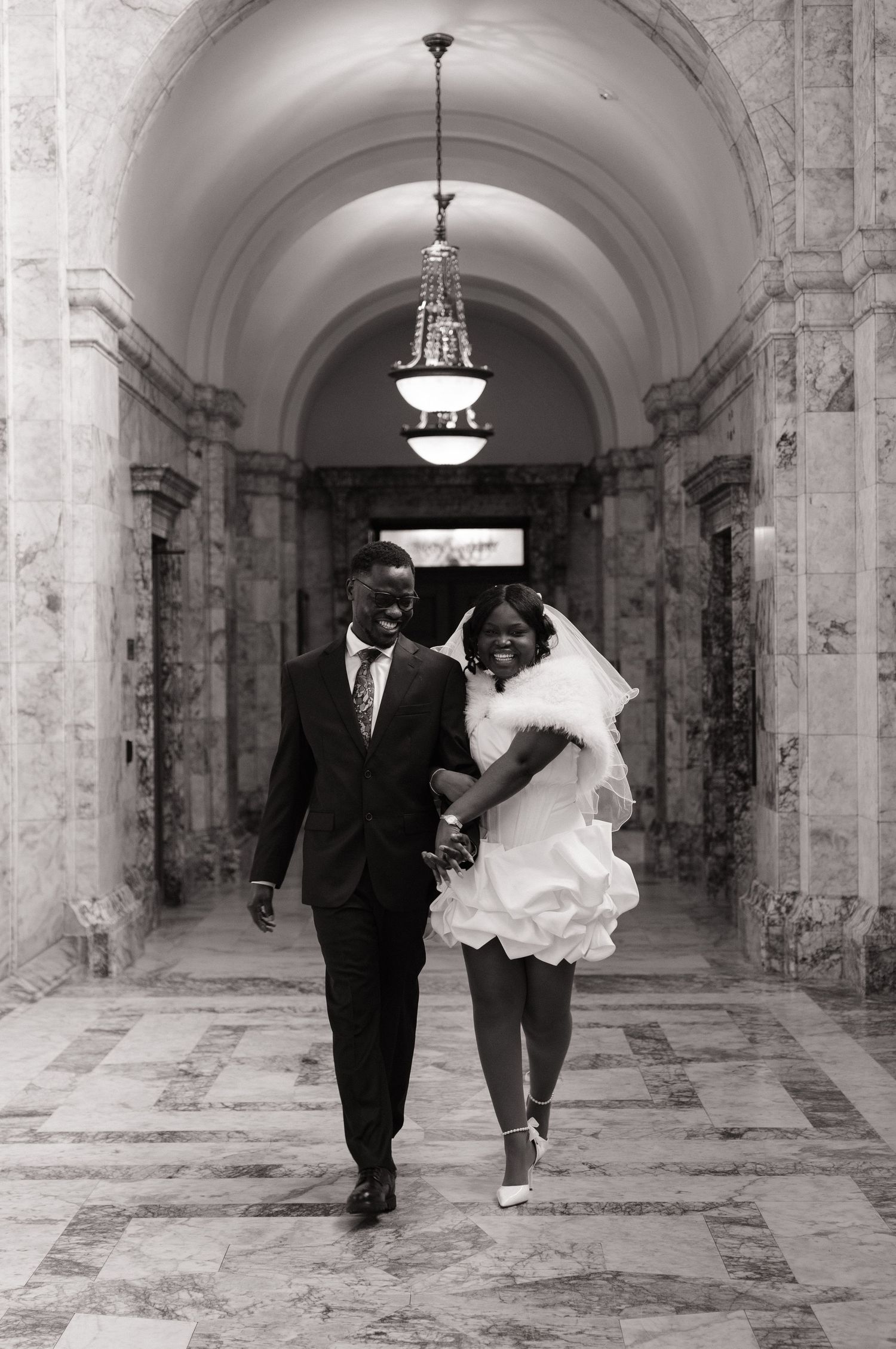 Newlyweds walking hand in hand through the Washington State Capitol in Olympia