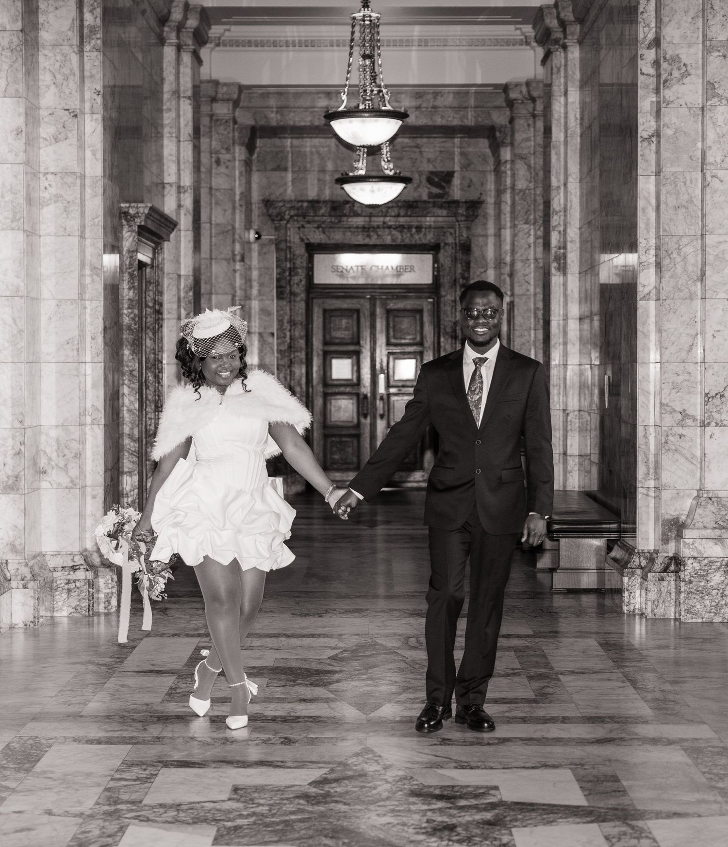 Newlyweds walking hand in hand through the Washington State Capitol in Olympia