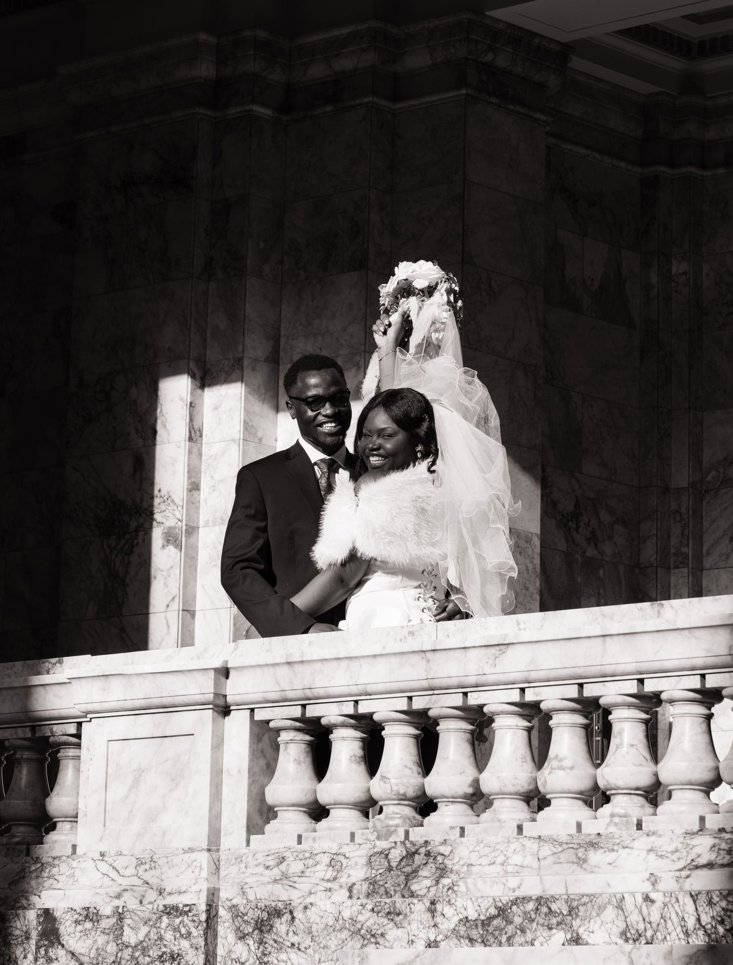 Newlyweds posing on a balcony inside the Washington State Capitol in Olympia