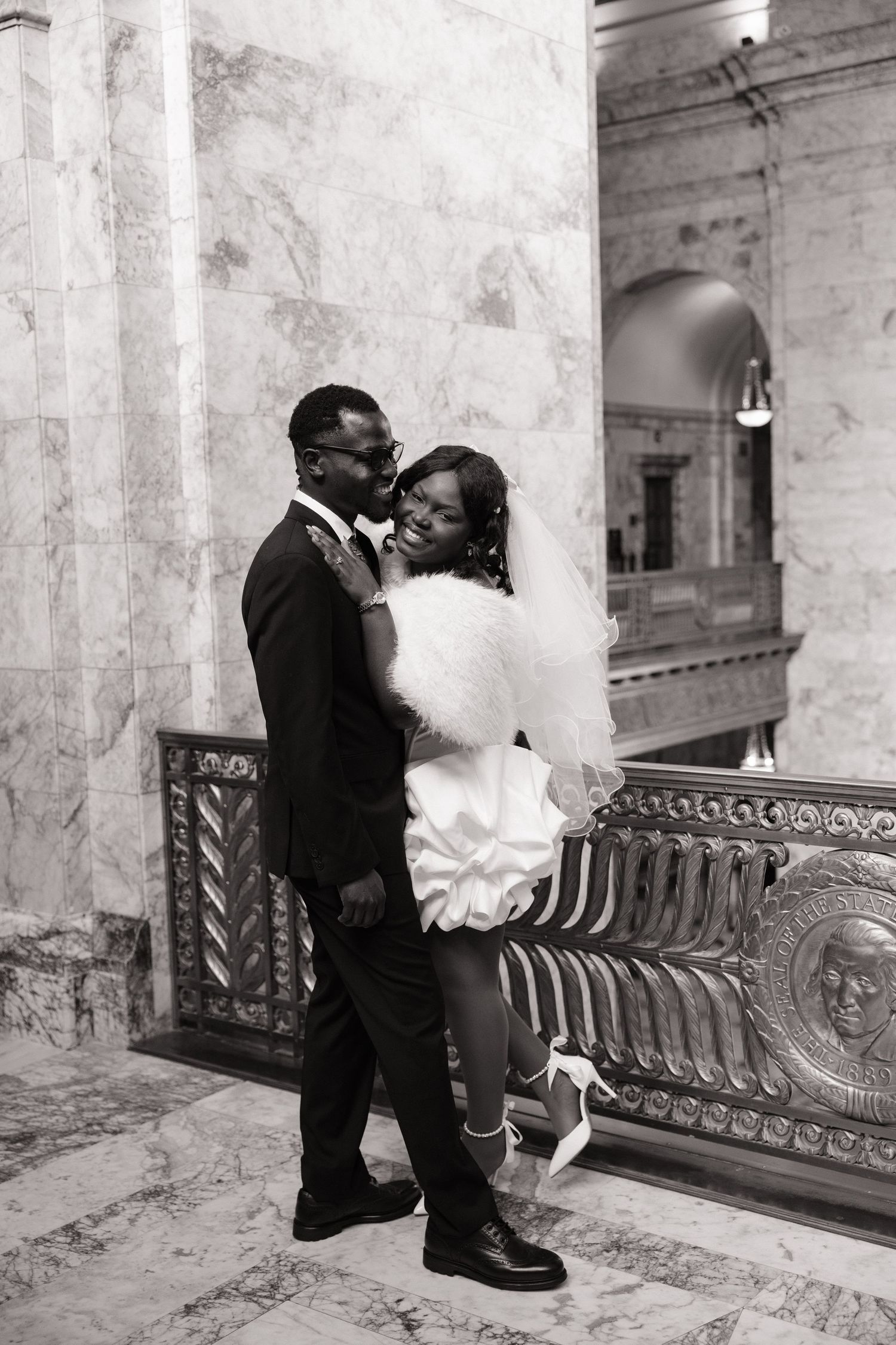 Bride and groom embracing inside the Washington State Capitol during their Olympia wedding