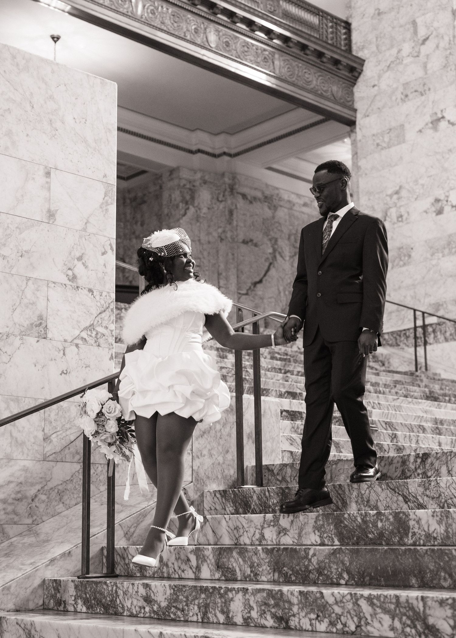 Bride and groom walking hand in hand on the Washington State Capitol stairs