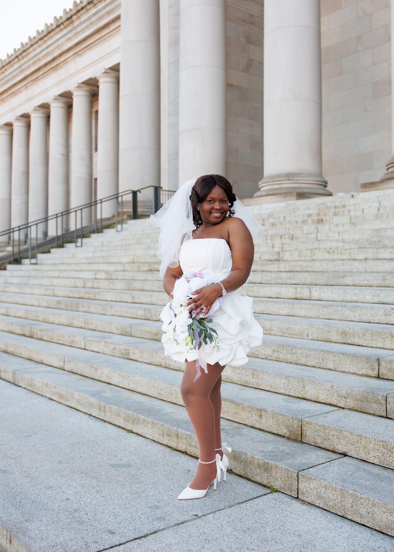 Bride smiling with her bouquet outside the Washington State Capitol in Olympia