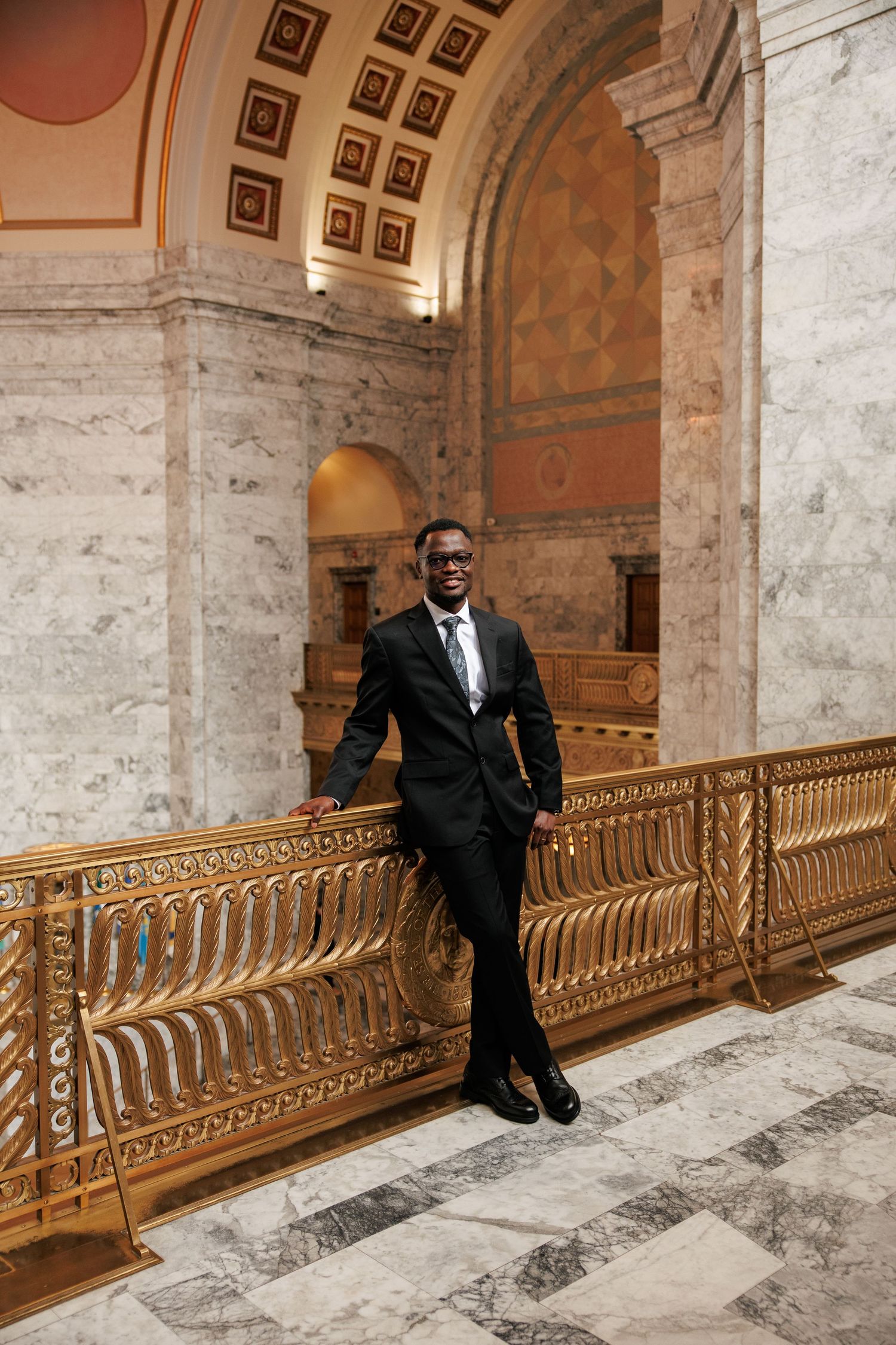 Groom portrait framed by the grand architecture inside the Washington State Capitol in Olympia