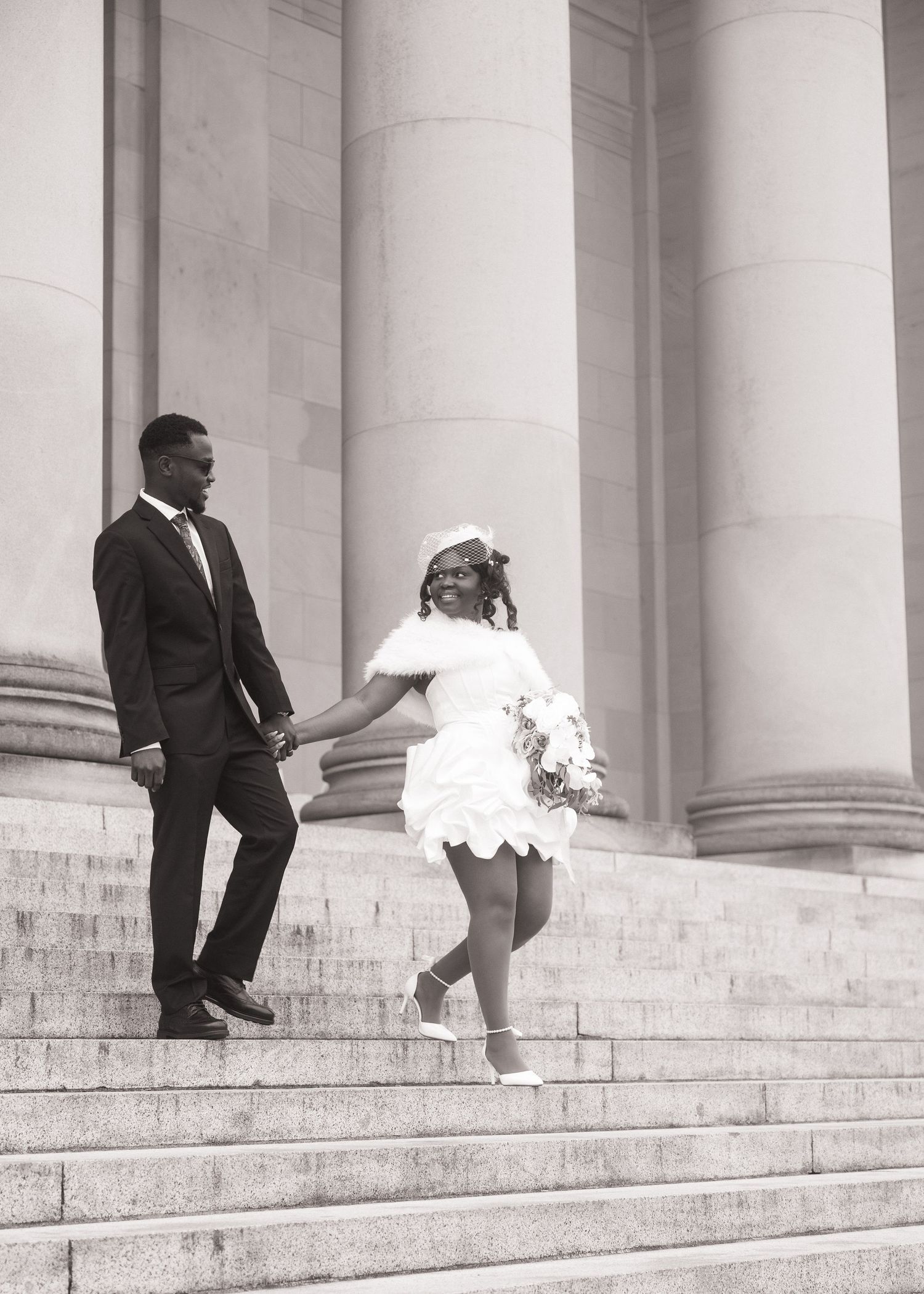Bride and groom walking hand in hand on the Washington State Capitol steps in Olympia