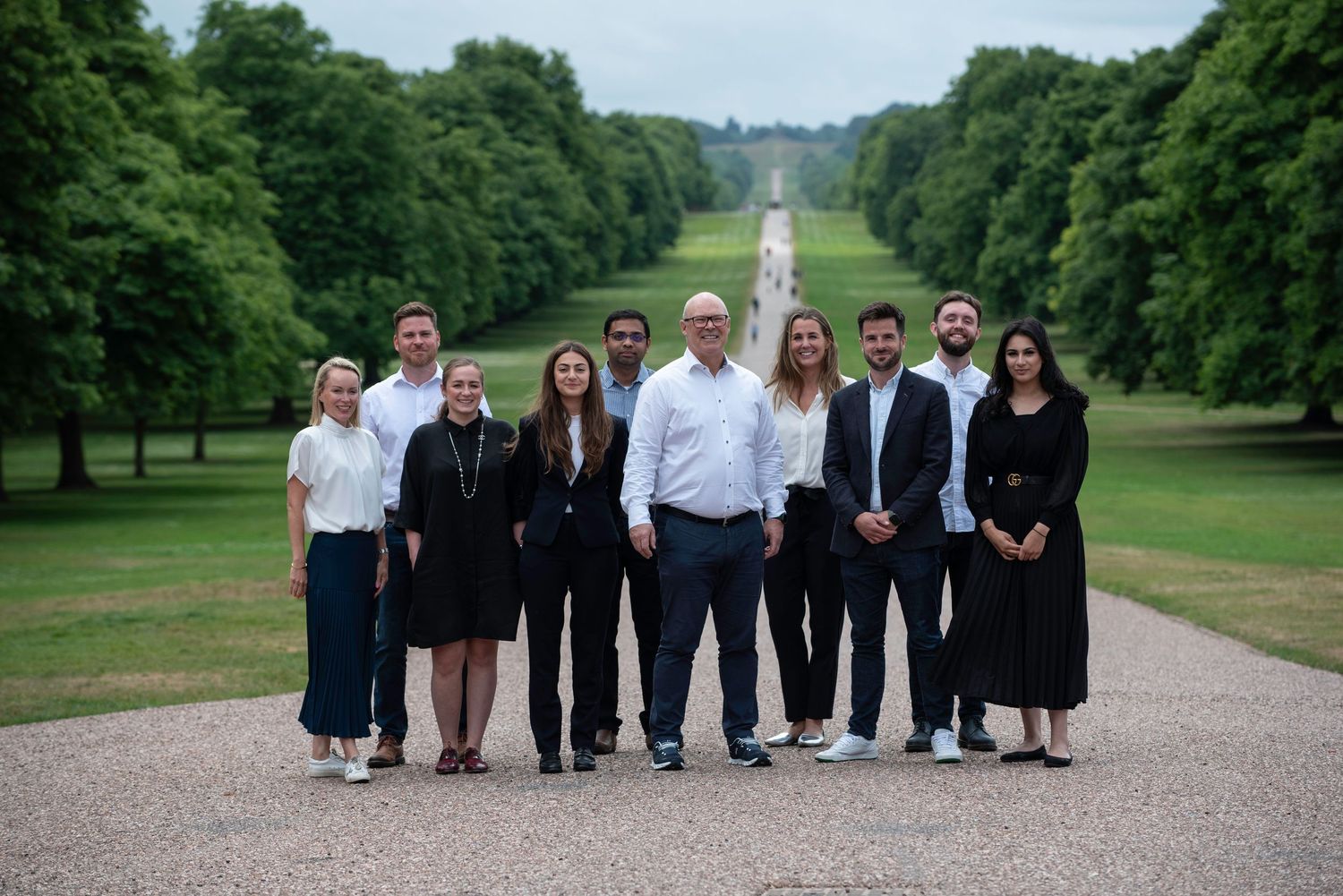Professional group photo on a tree-lined path at Windsor Great Park.  Business portrait