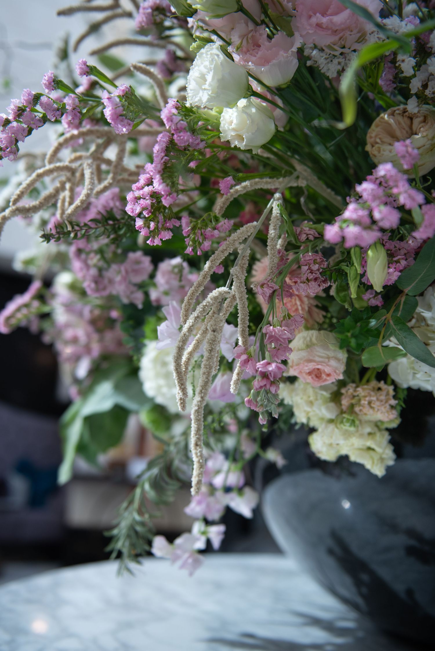 Lush close-up of pink, white, and lavender floral arrangement with cascading amaranthus blooms.  Fairmont Hotel, Windsor