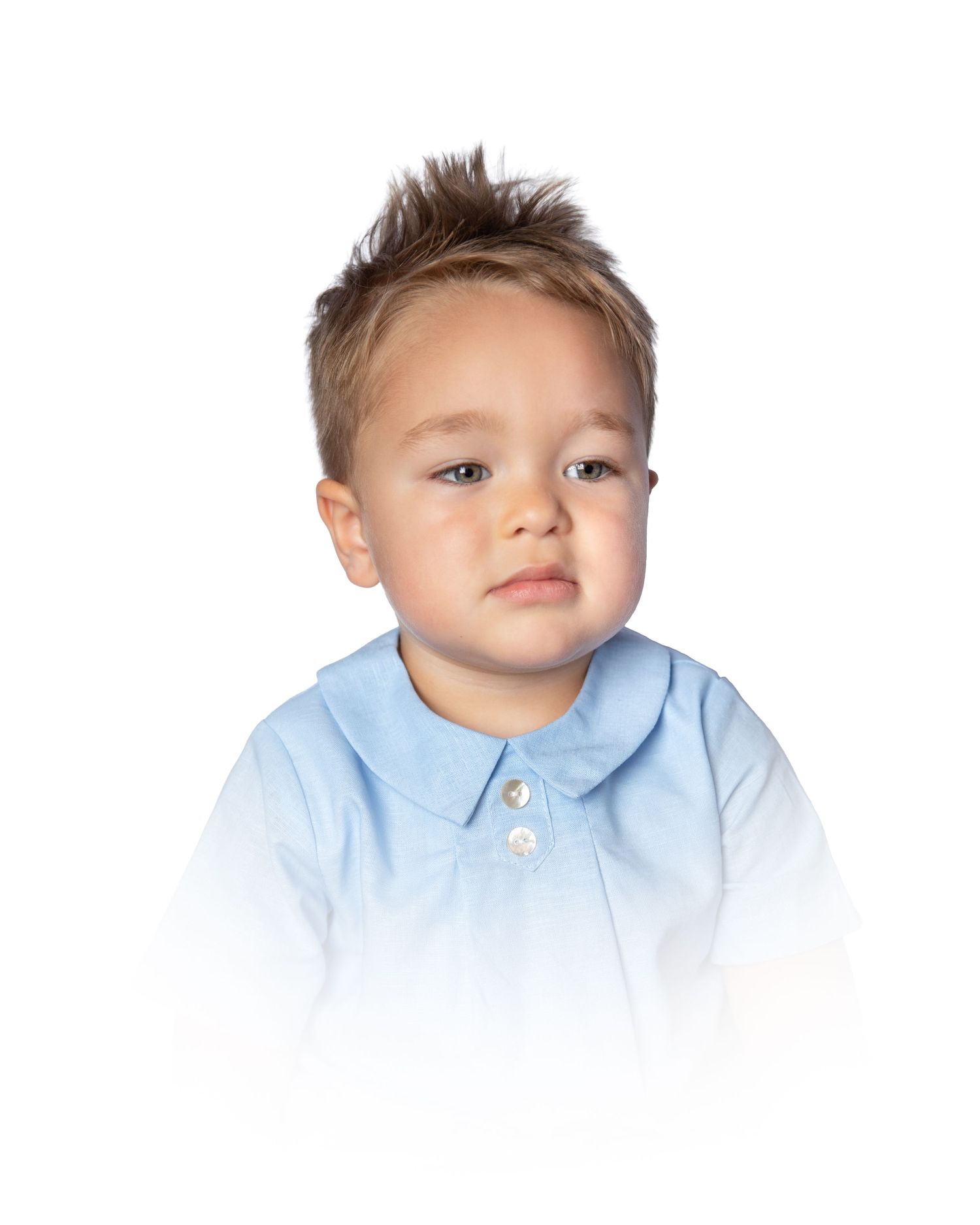 Toddler boy in a light blue Peter Pan collar shirt with button detail.