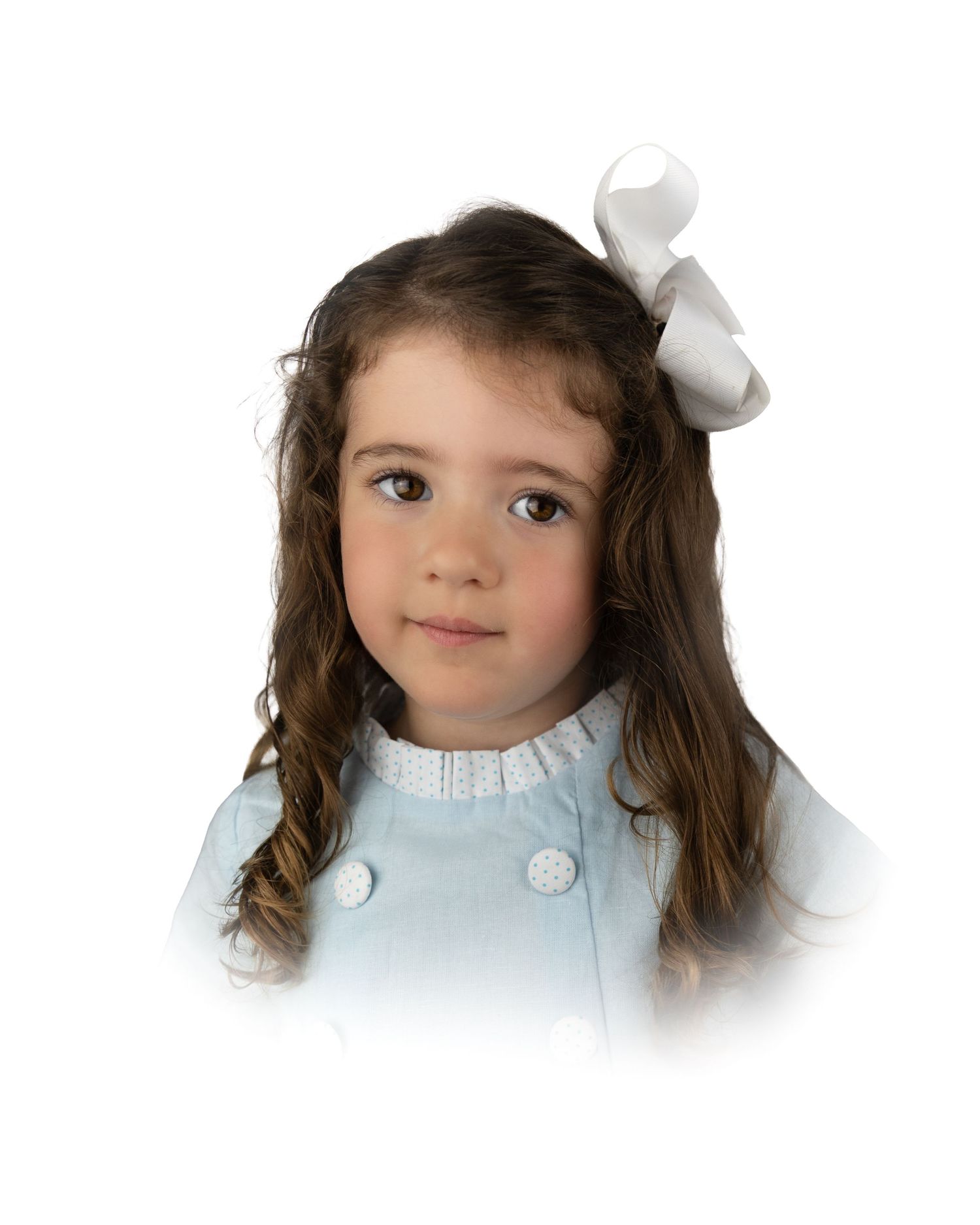 Little girl with long wavy brown hair and white bow in blue coat.