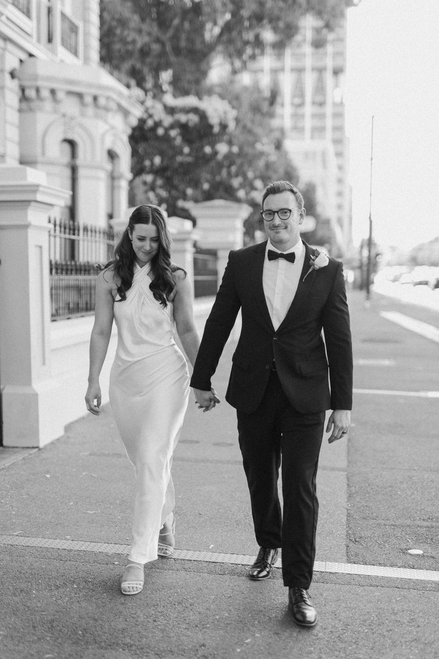 Brooke and Lloyd walking together beneath the trees on North Terrace.