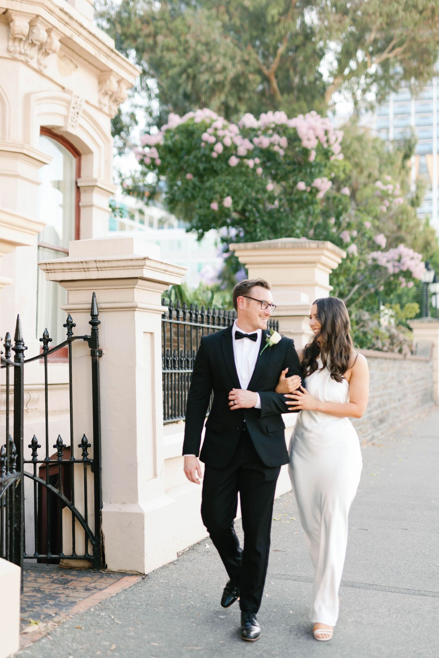 Brooke and Lloyd strolling arm in arm along North Terrace during their Adelaide elopement