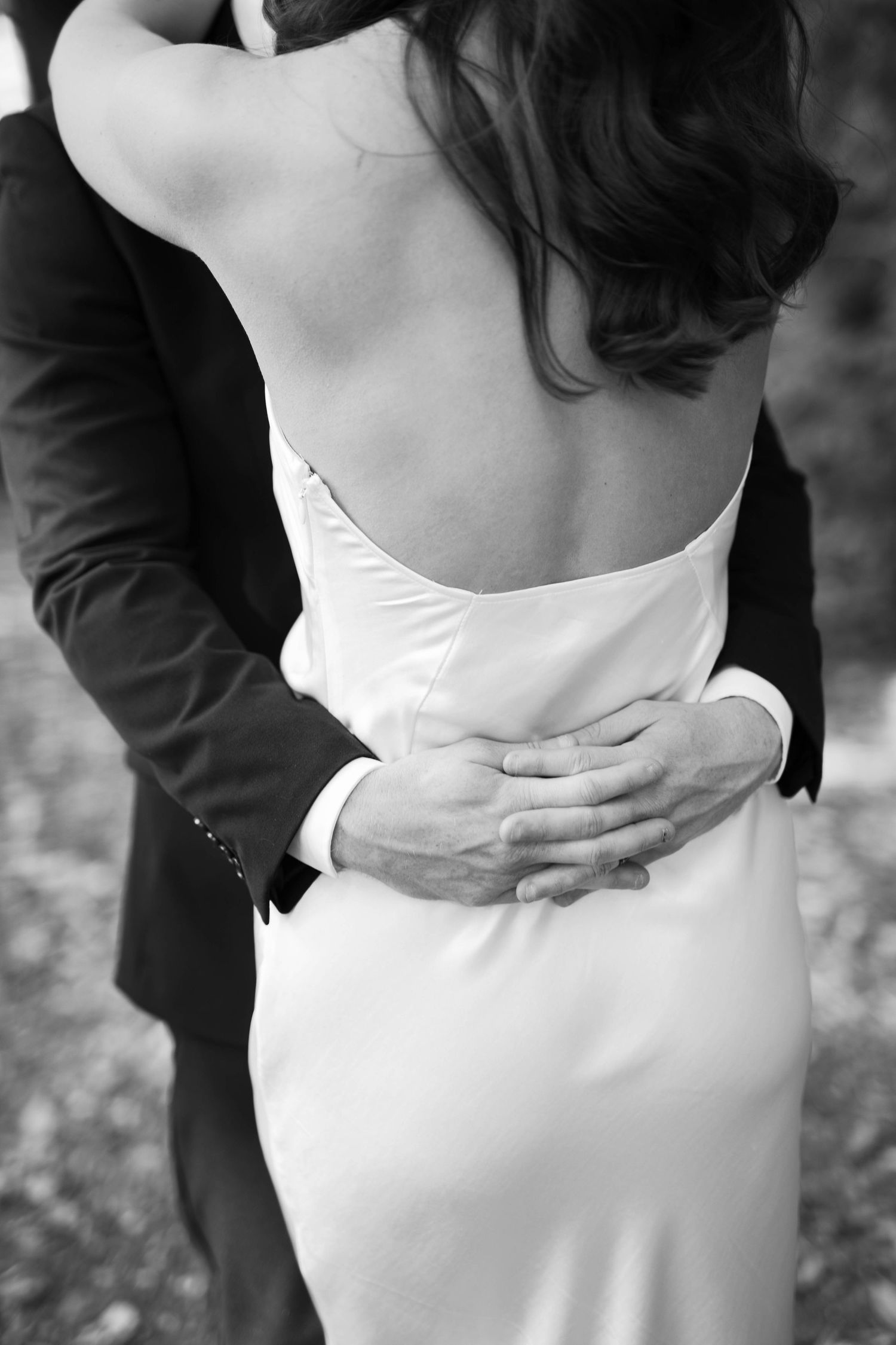 Black-and-white close-up of Lloyd holding Brooke around the waist.