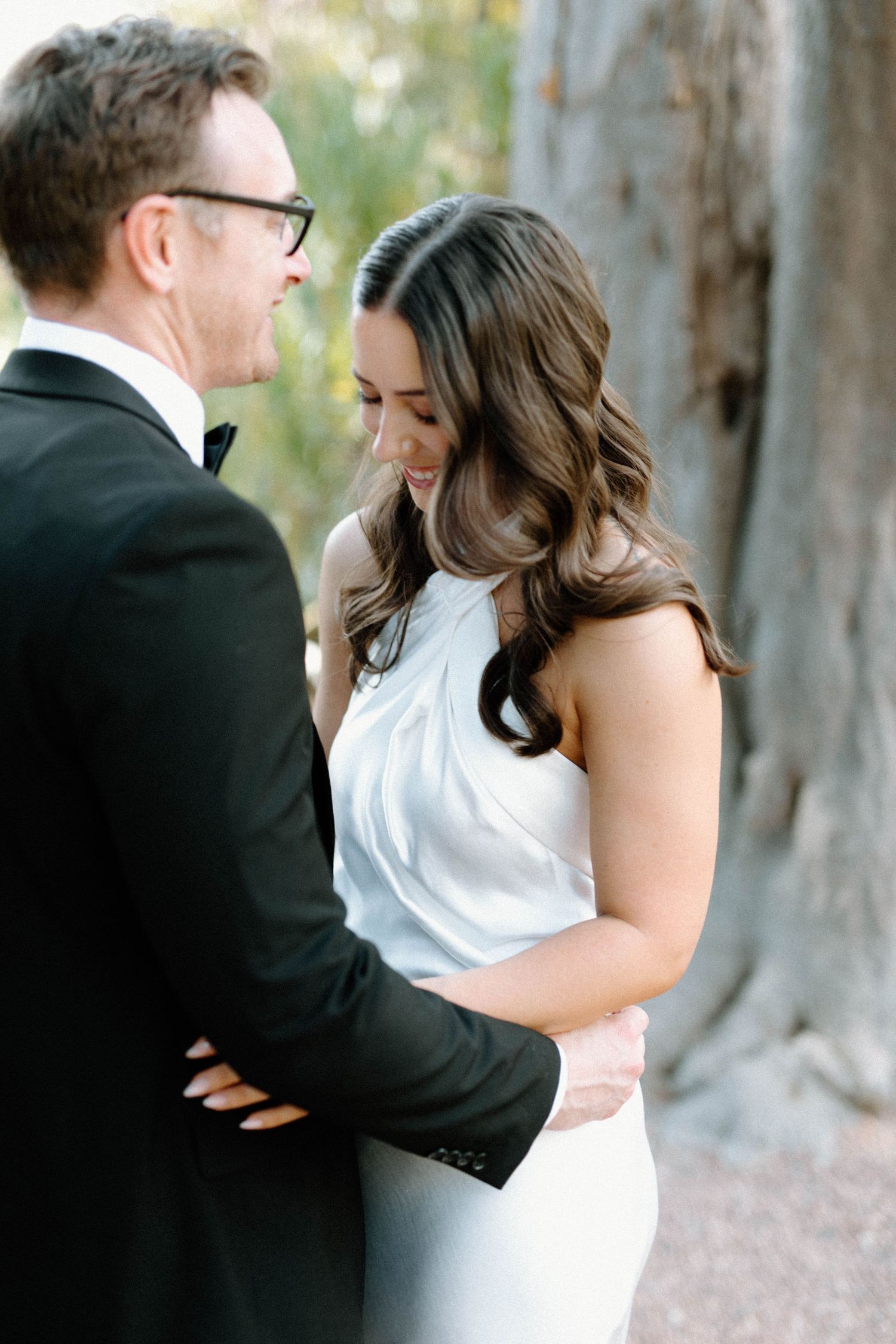 Lloyd holding Brooke close beneath the trees in Adelaide Botanic Garden