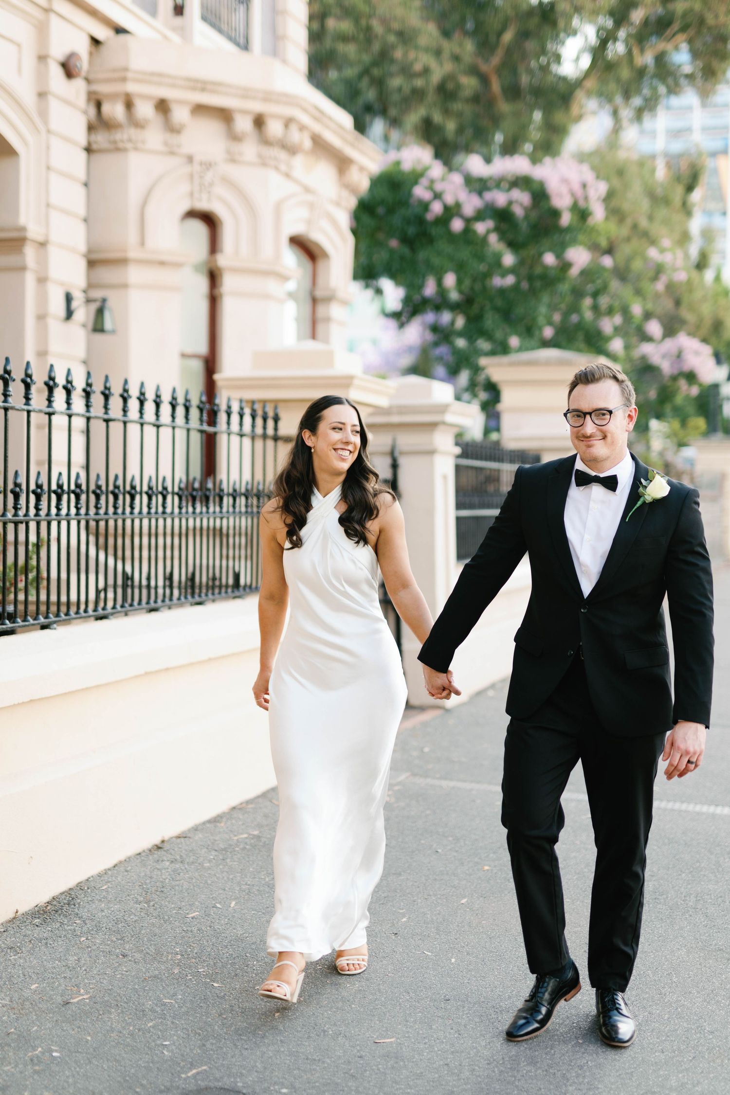 Brooke and Lloyd walking towards the camera along North Terrace after their Adelaide elopement.