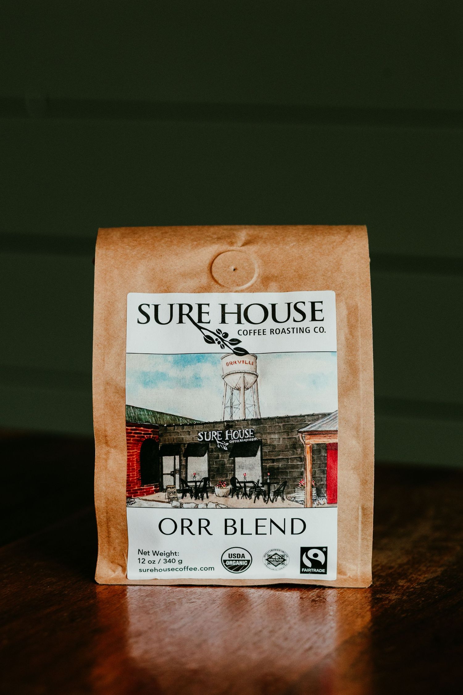 Sure House Coffee Roasting Co. Orr Blend organic fair trade coffee bag on wooden surface.