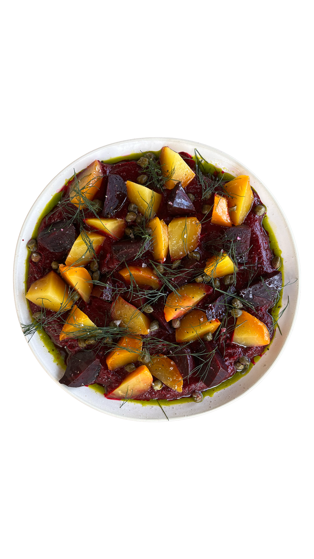 Roasted red and golden beet salad with fresh dill in herb oil dressing served in a round white ceramic bowl.