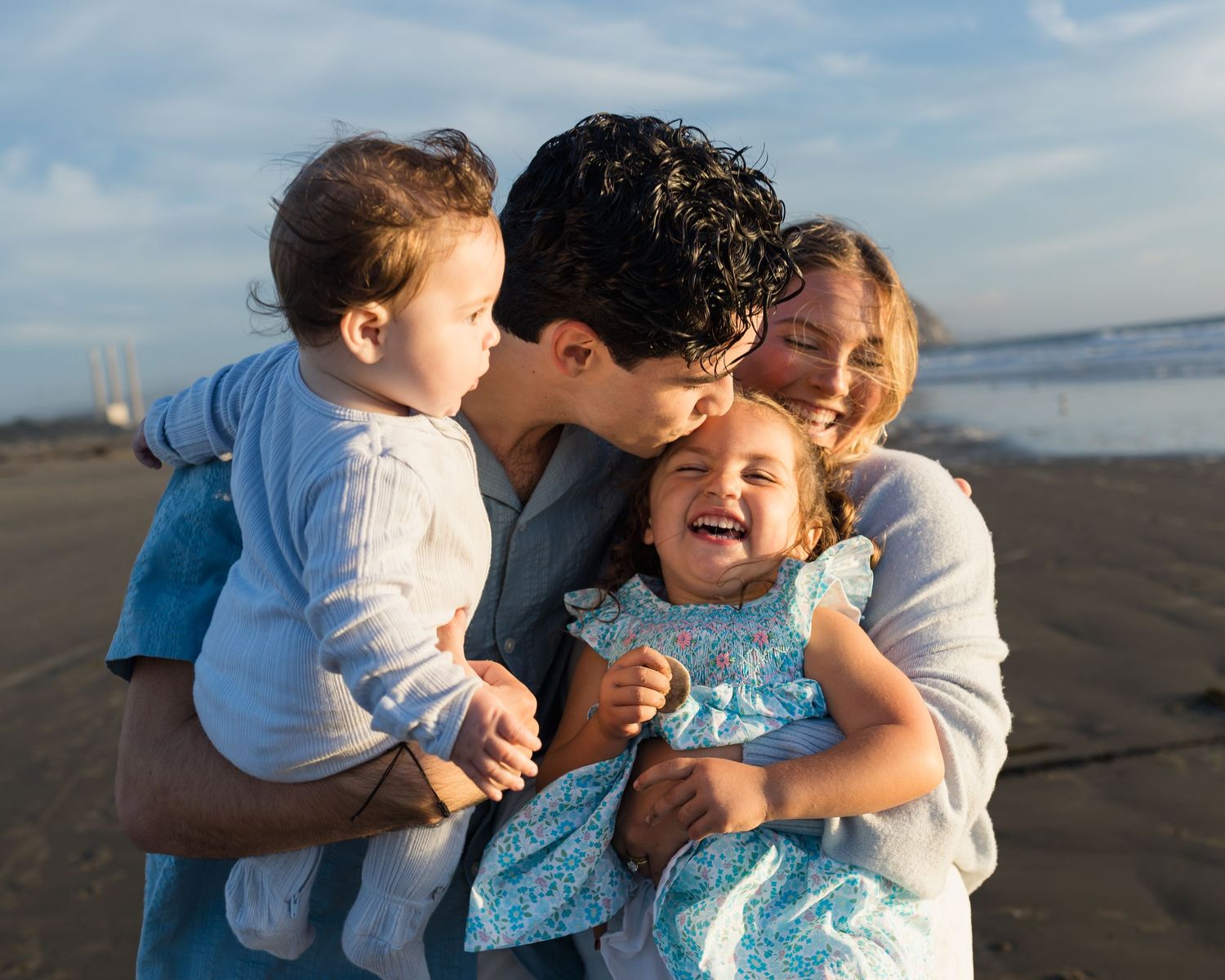 Father and children sharing a joyful moment during a natural family photography session on the Central Coast of California