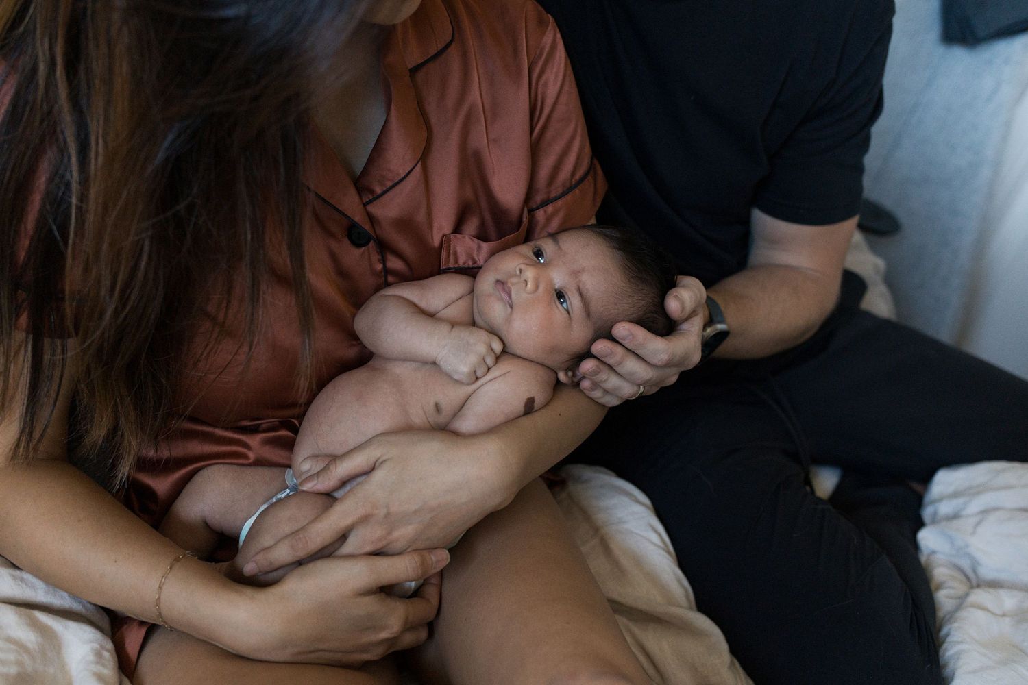 Mother holding her newborn baby during an in-home lifestyle session