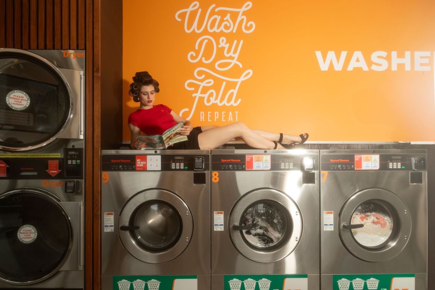 Editorial fashion photography in Sydney set in a laundromat, featuring bold styling, retro concept and cinematic composition.
