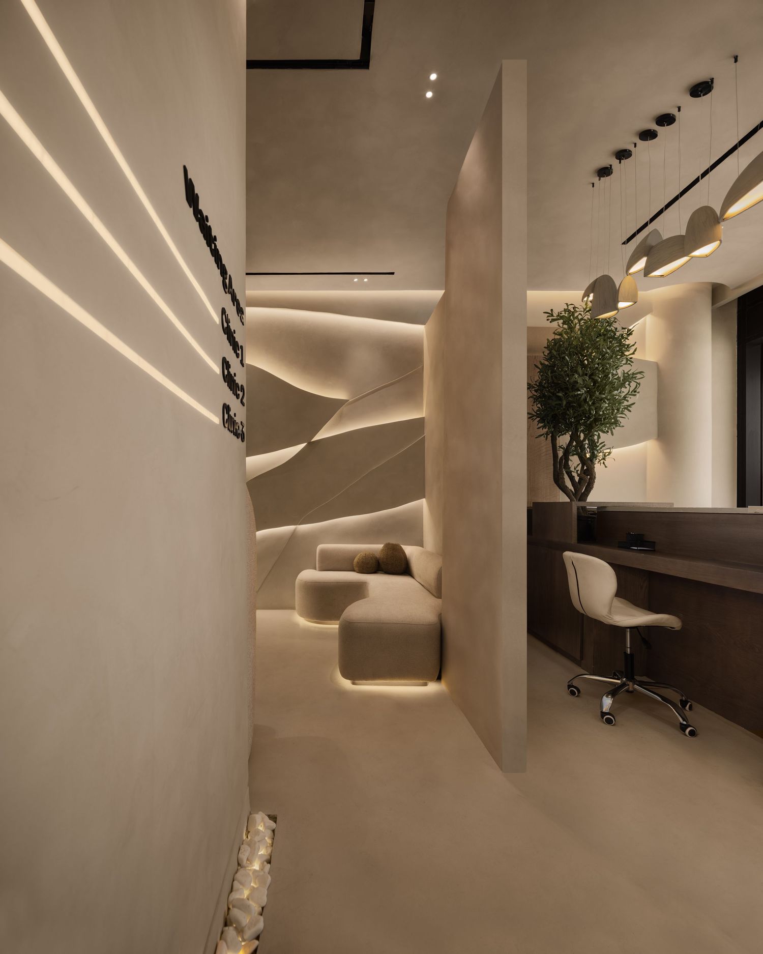 Contemporary neutral-toned salon interior with curved sculptural walls, LED lighting, and workstation.