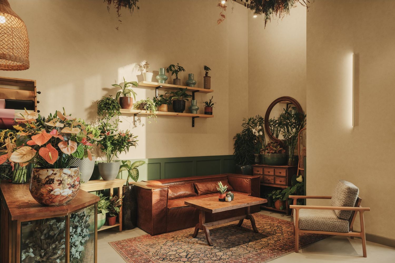 Cozy bohemian interior with leather sofa, wooden furniture, lush plants, and warm natural lighting.