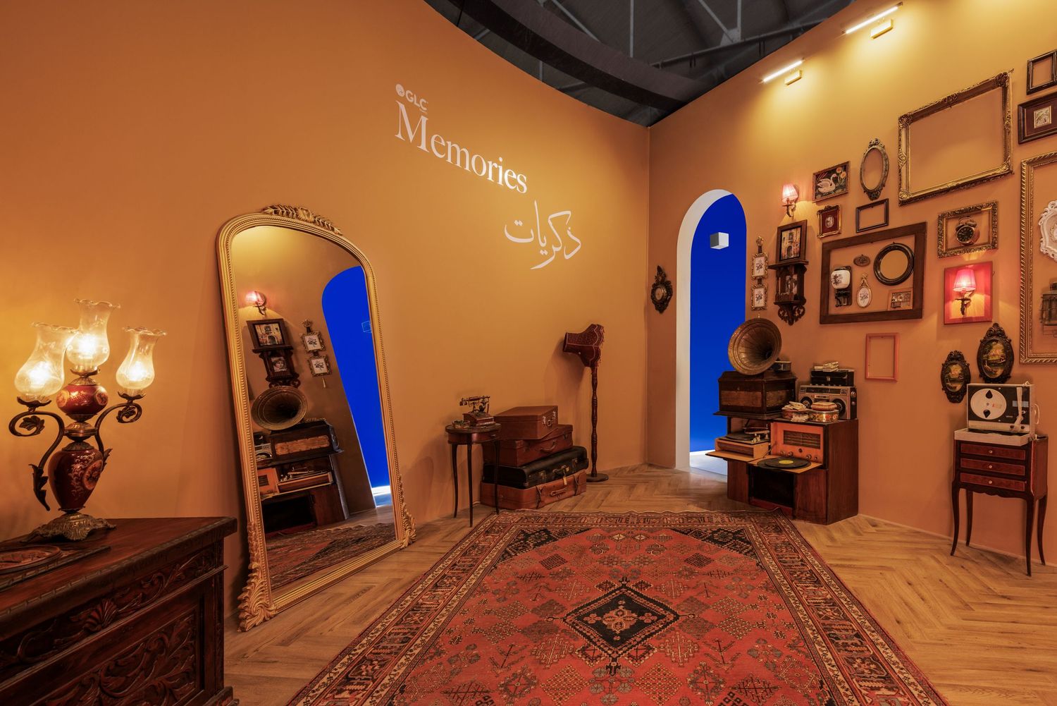 Warm amber room titled Memories with arched doorways, vintage mirror, Persian rug, and antique decor.