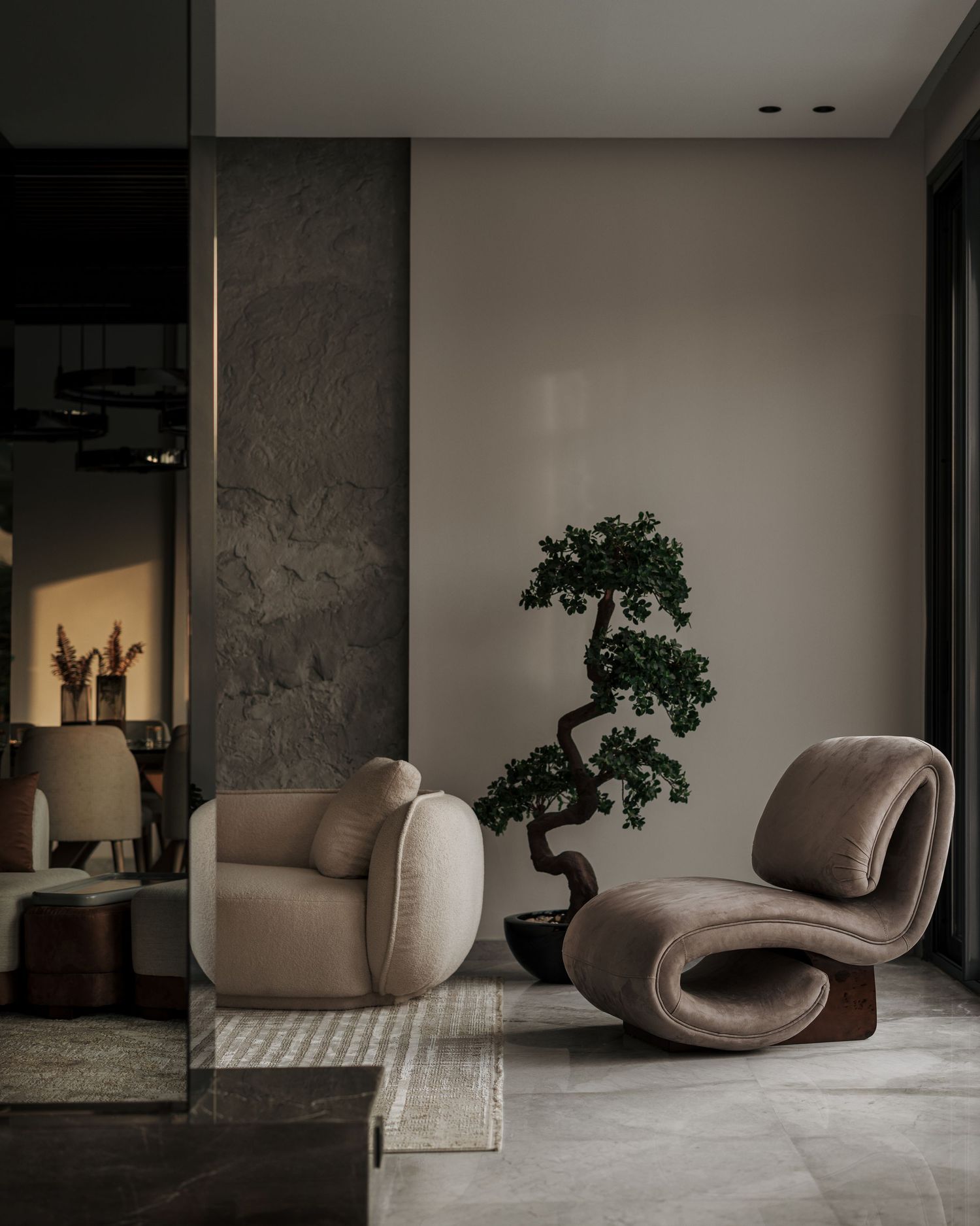 Serene living space featuring two sculptural curved lounge chairs in taupe beside a bonsai tree on polished marble floors.