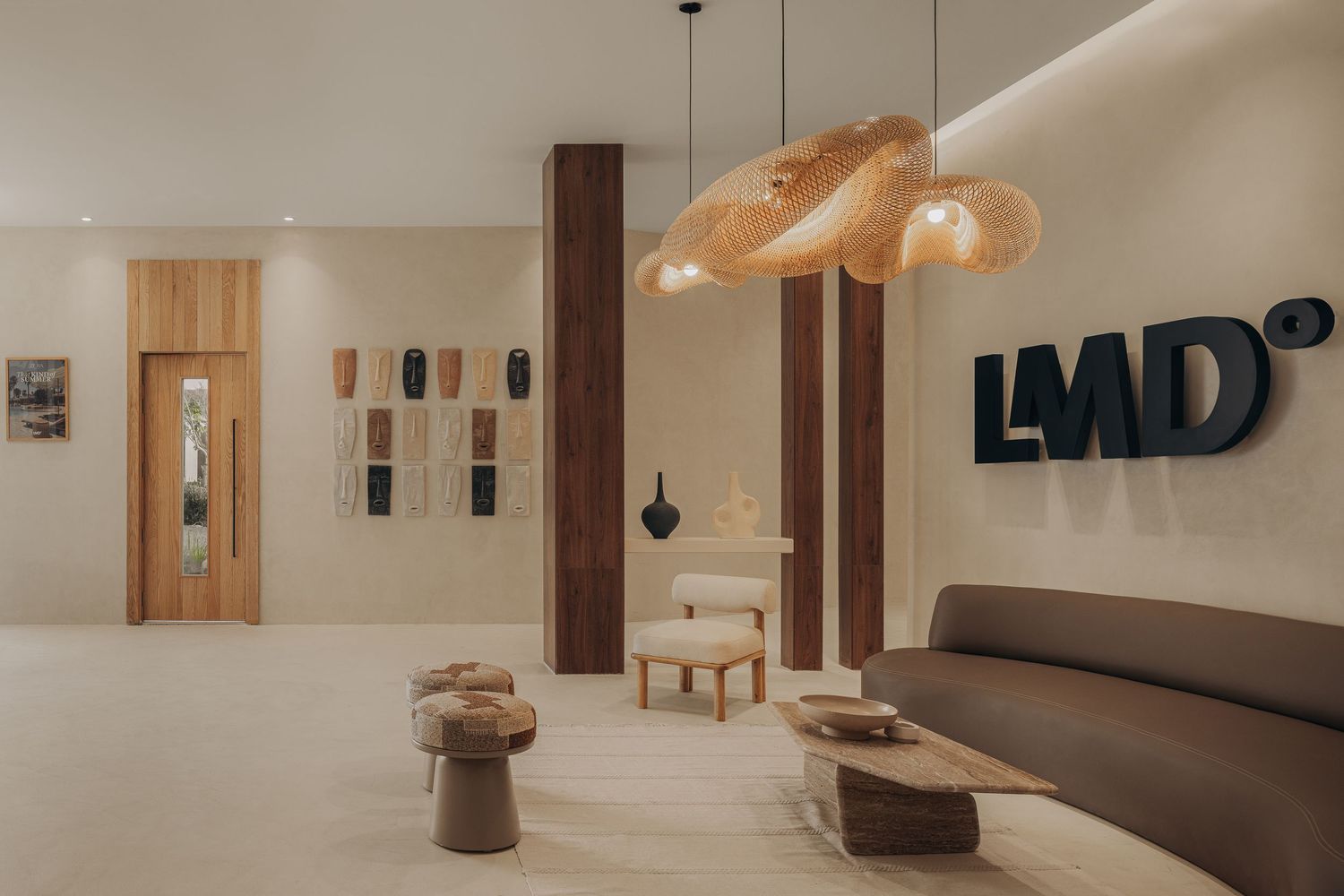 Luxurious LMD spa reception area featuring rattan pendant lights, organic wood furniture, and earthy neutral tones.