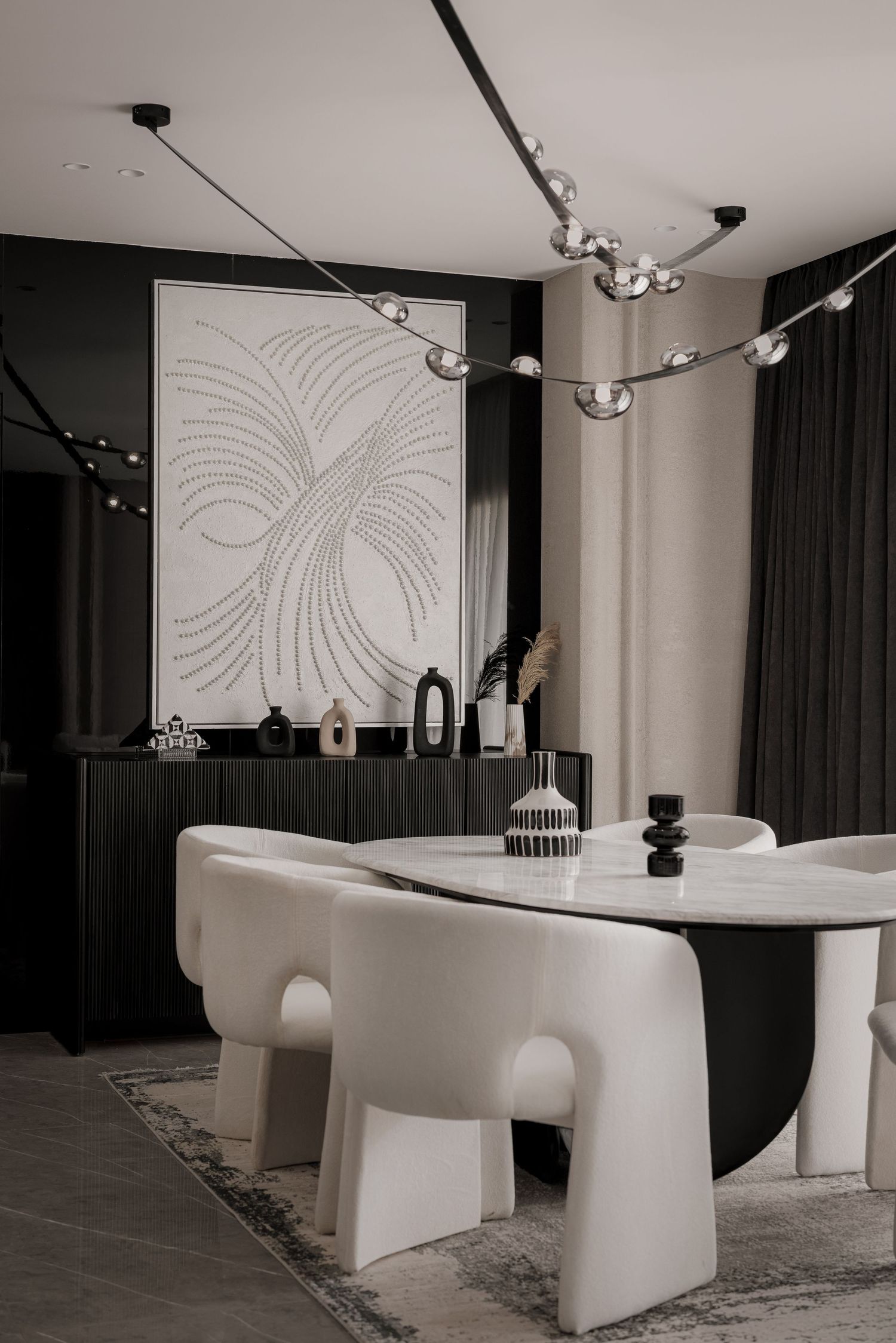 Sophisticated dining room with white curved chairs, marble table, sculptural chandelier, and botanical wall art.