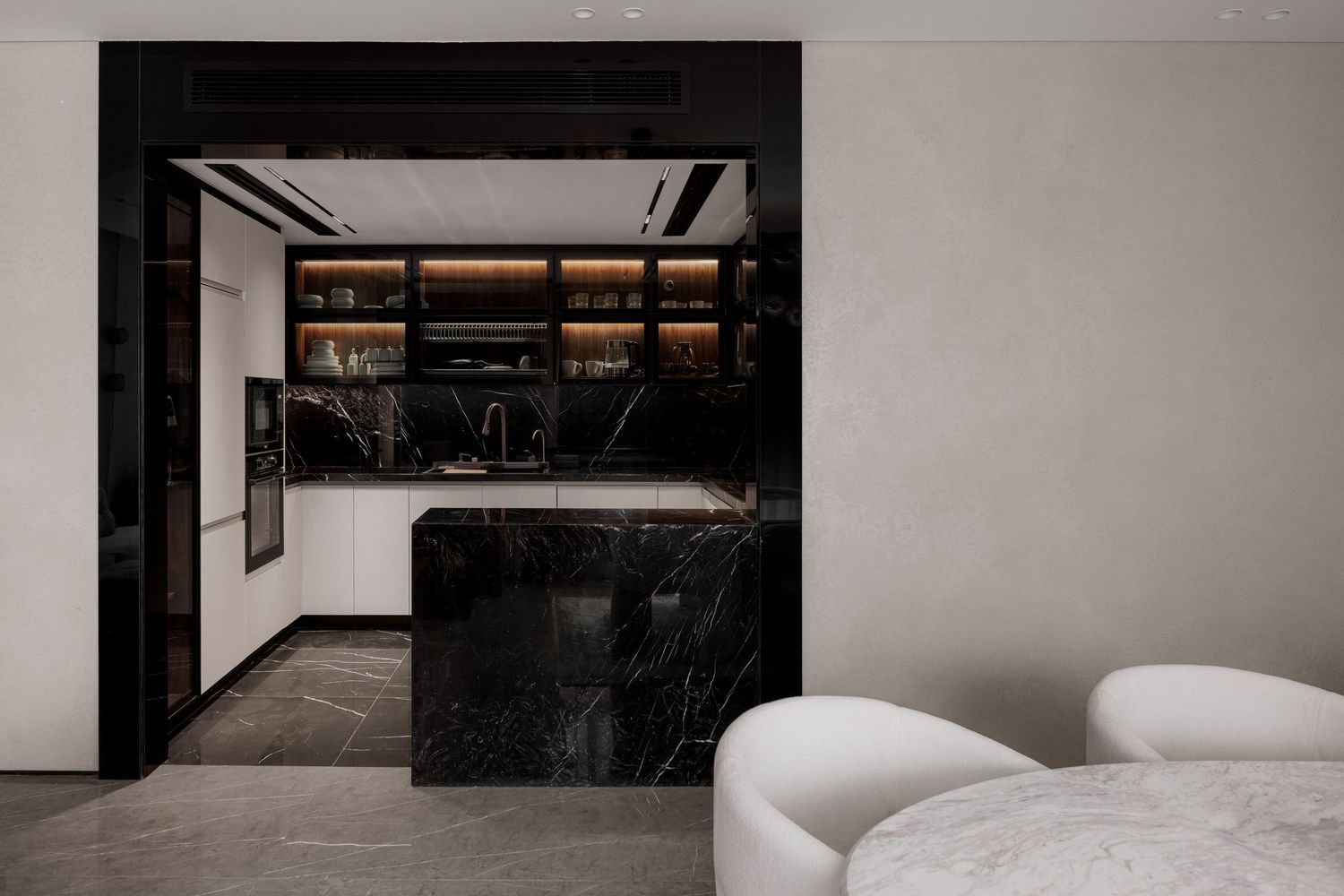 Sleek modern kitchen with black marble island, dark cabinetry, and open shelving.