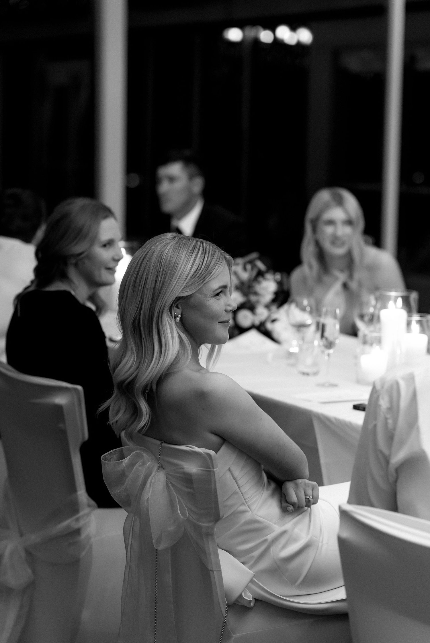 A sequence of black and white photos showing wedding guests reacting emotionally during reception speeches.