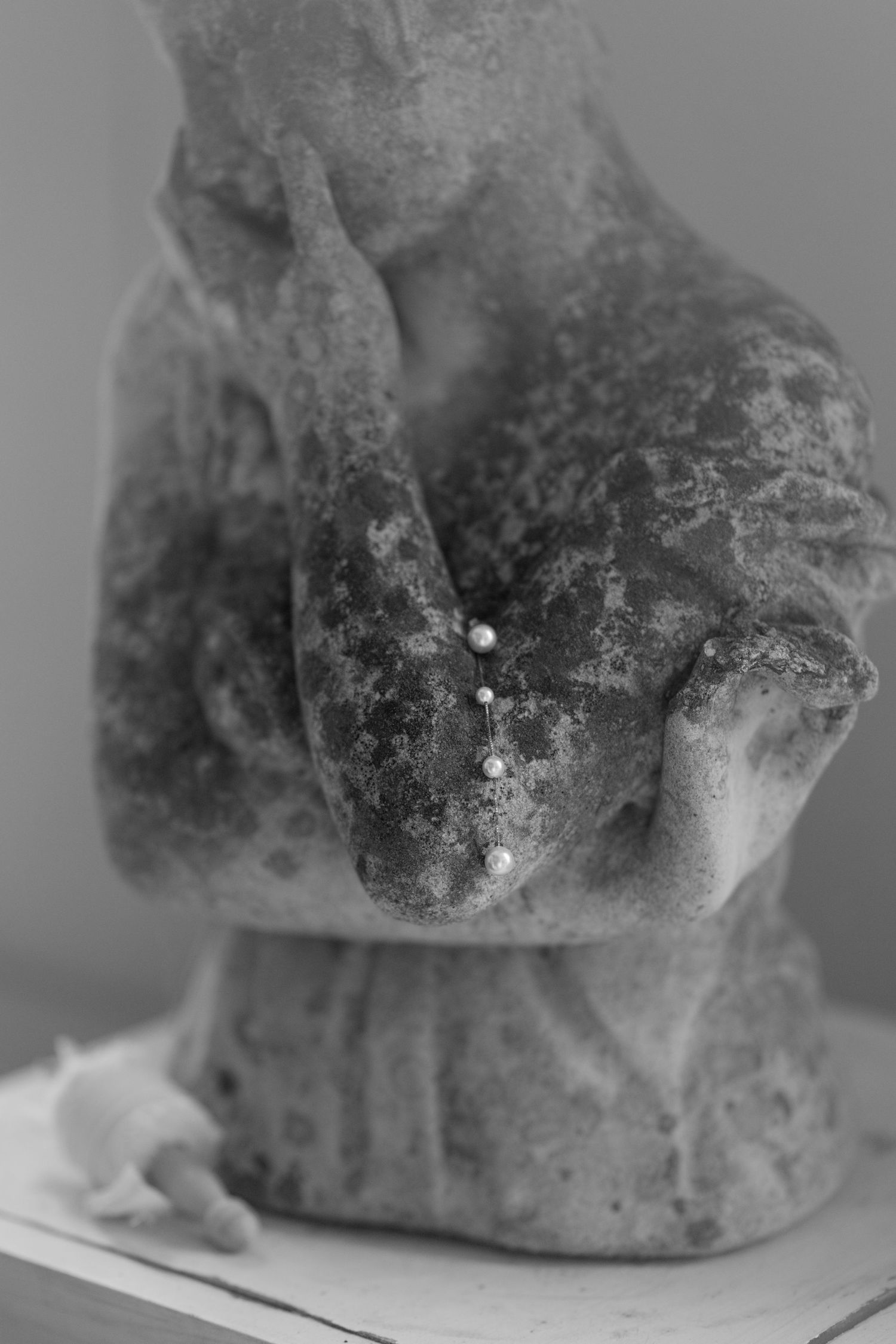 Artistic black and white macro photograph of a weathered stone sculpture.
