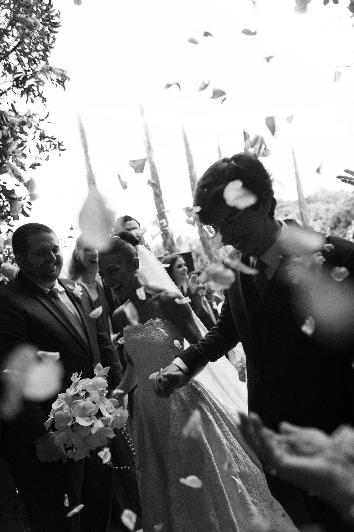 A black and white photo sequence shows a crowd celebrating with confetti and joyful expressions at an outdoor event.