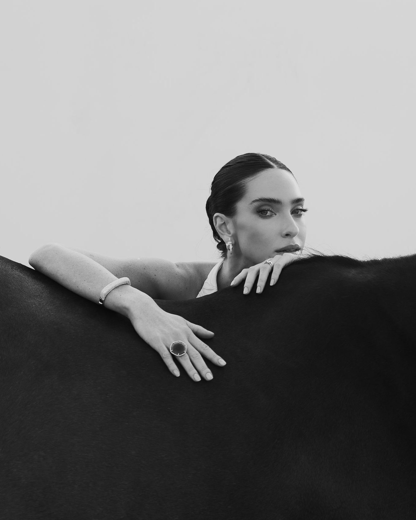 Artistic black and white portrait series showing hands reaching across dark shadows in minimalist composition.